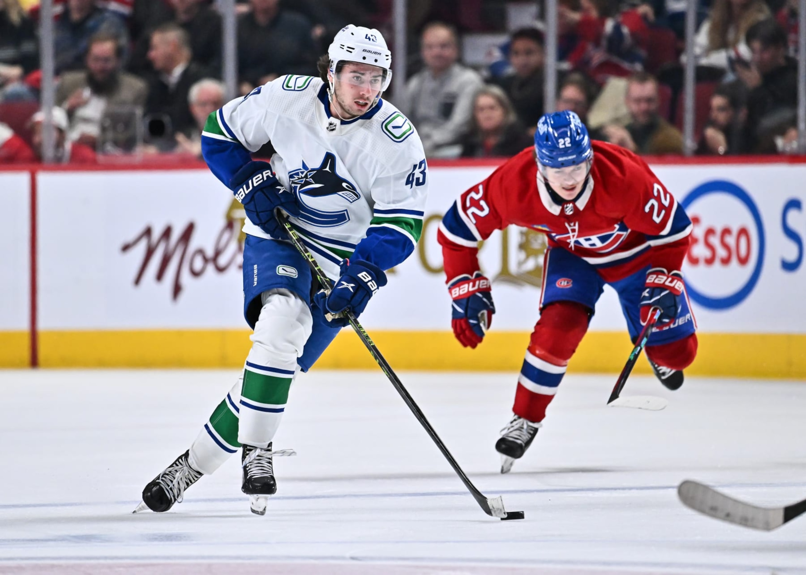 MONTREAL, CANADA - NOVEMBER 09:  Quinn Hughes #43 of the Vancouver Canucks skates the puck during the third period against the Montreal Canadiens at Centre Bell on November 9, 2022 in Montreal, Quebec, Canada.  The Montreal Canadiens defeated the Vancouver Canucks 5-2.  (Photo by Minas Panagiotakis/Getty Images)