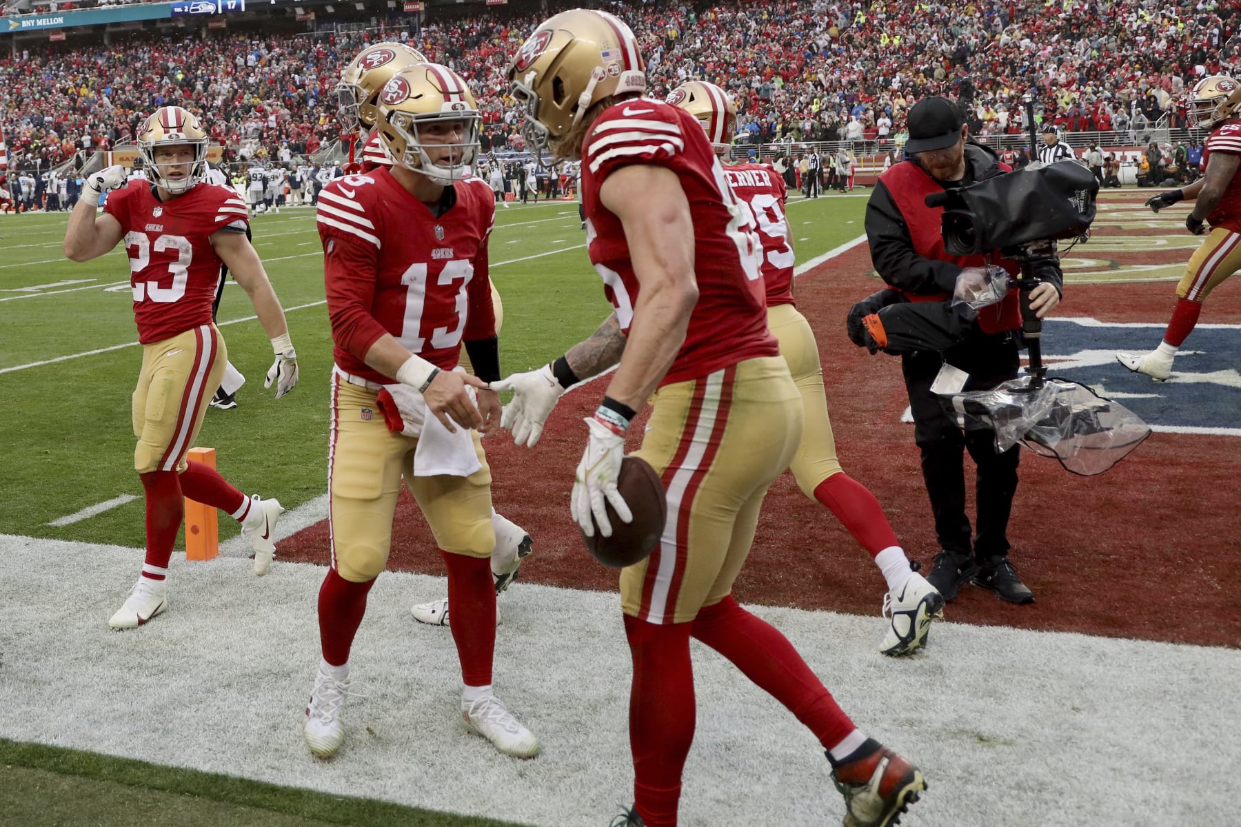 San Francisco 49ers quarterback Brock Purdy (13) celebrates with tight end George Kittle (85) after a touchdown during an NFL wild card playoff football game against the Seattle Seahawks on Saturday, Jan.14, 2023, in Santa Clara, Calif. (AP Photo/Scot Tucker)