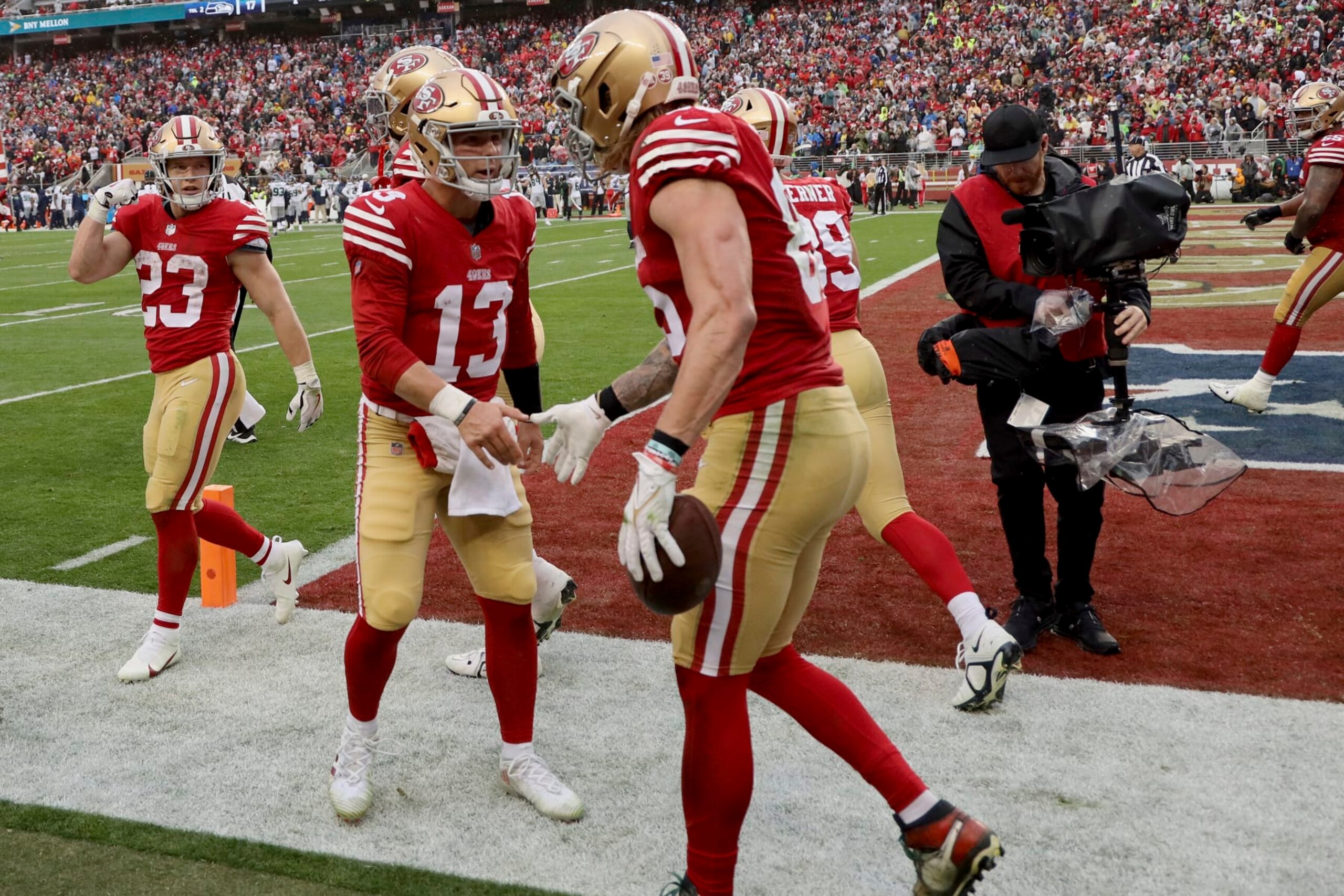 San Francisco 49ers quarterback Brock Purdy (13) celebrates with tight end George Kittle (85) after a touchdown during an NFL wild card playoff football game against the Seattle Seahawks on Saturday, Jan.14, 2023, in Santa Clara, Calif. (AP Photo/Scot Tucker)