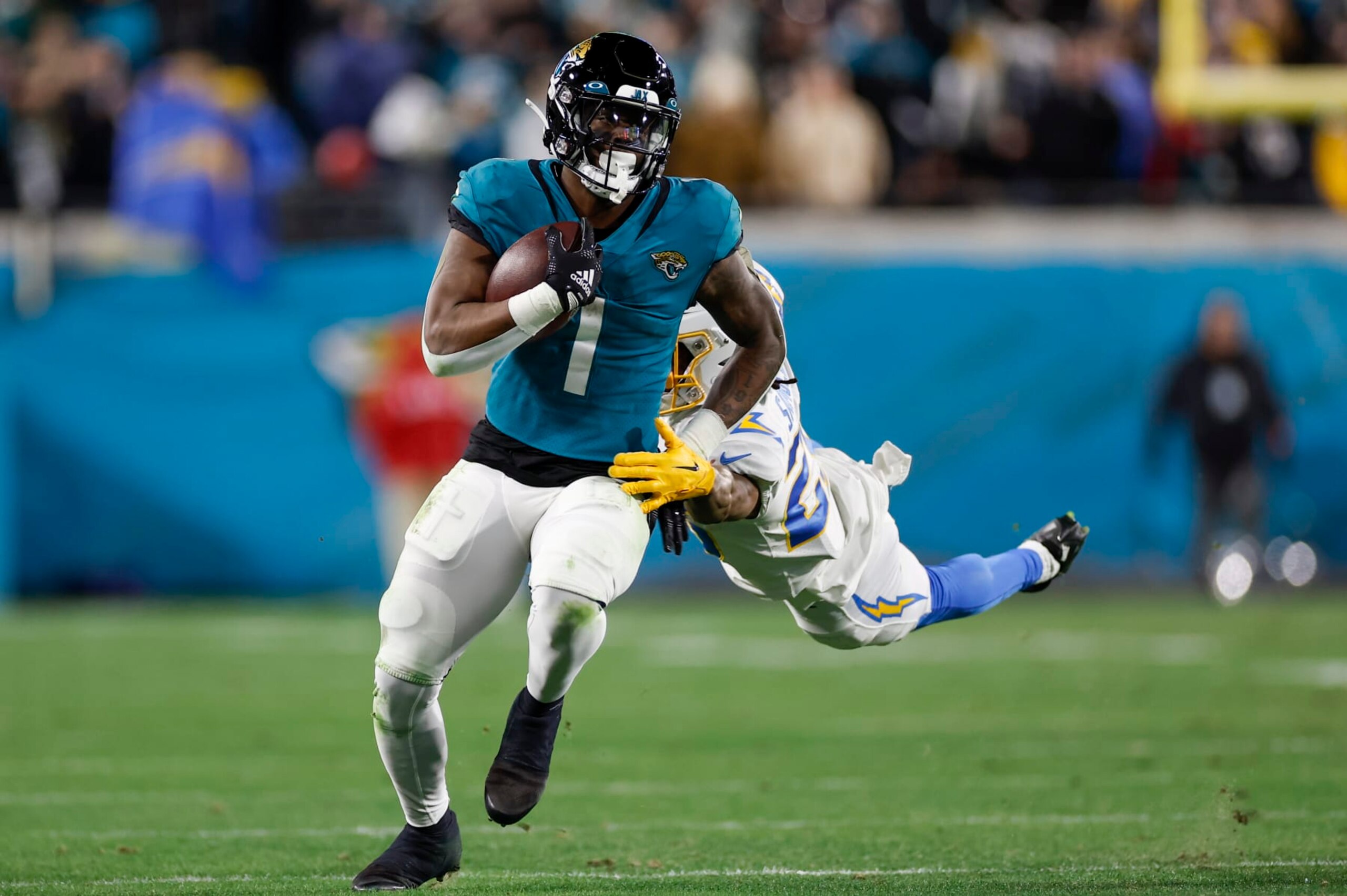 JACKSONVILLE, FL - JANUARY 14: Jacksonville Jaguars running back Travis Etienne Jr. (1) runs with the ball during the game between the Los Angeles Chargers and the Jacksonville Jaguars on January 14, 2023 at TIAA Bank Field in Jacksonville, Fl. (Photo by David Rosenblum/Icon Sportswire via Getty Images)