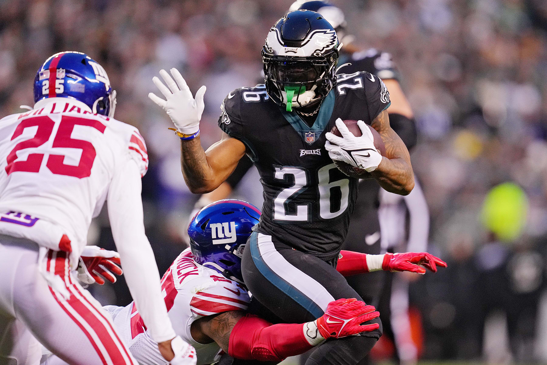 PHILADELPHIA, PENNSYLVANIA - JANUARY 08: Jason Pinnock #27 of the New York Giants tackles Miles Sanders #26 of the Philadelphia Eagles during the first quarter at Lincoln Financial Field on January 08, 2023 in Philadelphia, Pennsylvania. (Photo by Mitchell Leff/Getty Images)