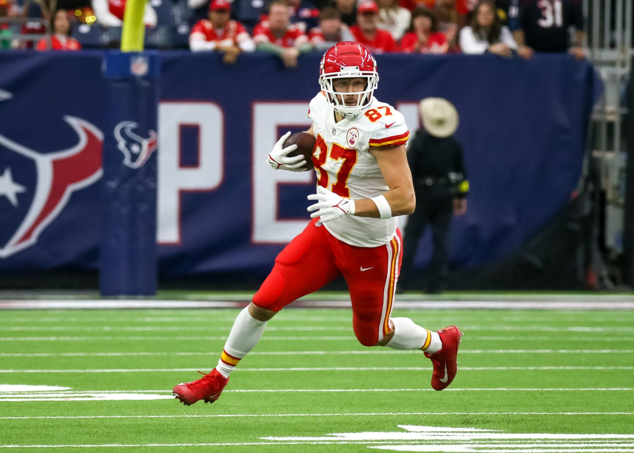 HOUSTON, TX - DECEMBER 18:  Kansas City Chiefs tight end Travis Kelce (87) carries the ball in overtime during the NFL game between the Kansas City Chiefs and Houston Texans on December 18, 2022 at NRG Stadium in Houston, Texas.  (Photo by Leslie Plaza Johnson/Icon Sportswire via Getty Images)
