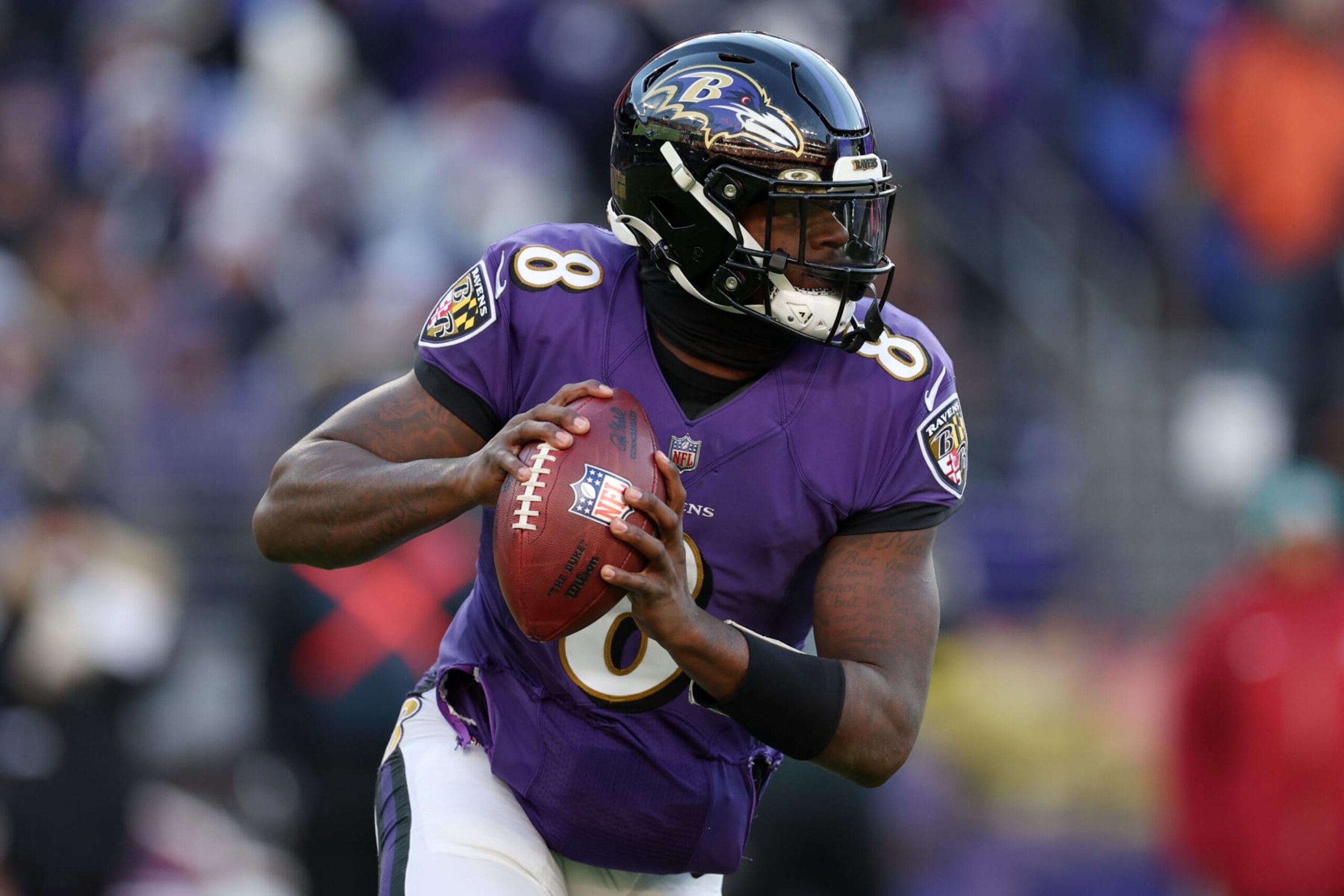 BALTIMORE, MARYLAND - NOVEMBER 20: Lamar Jackson #8 of the Baltimore Ravens rolls out of the pocket in the fourth quarter of a game against the Carolina Panthers at M&T Bank Stadium on November 20, 2022 in Baltimore, Maryland. (Photo by Rob Carr/Getty Images)