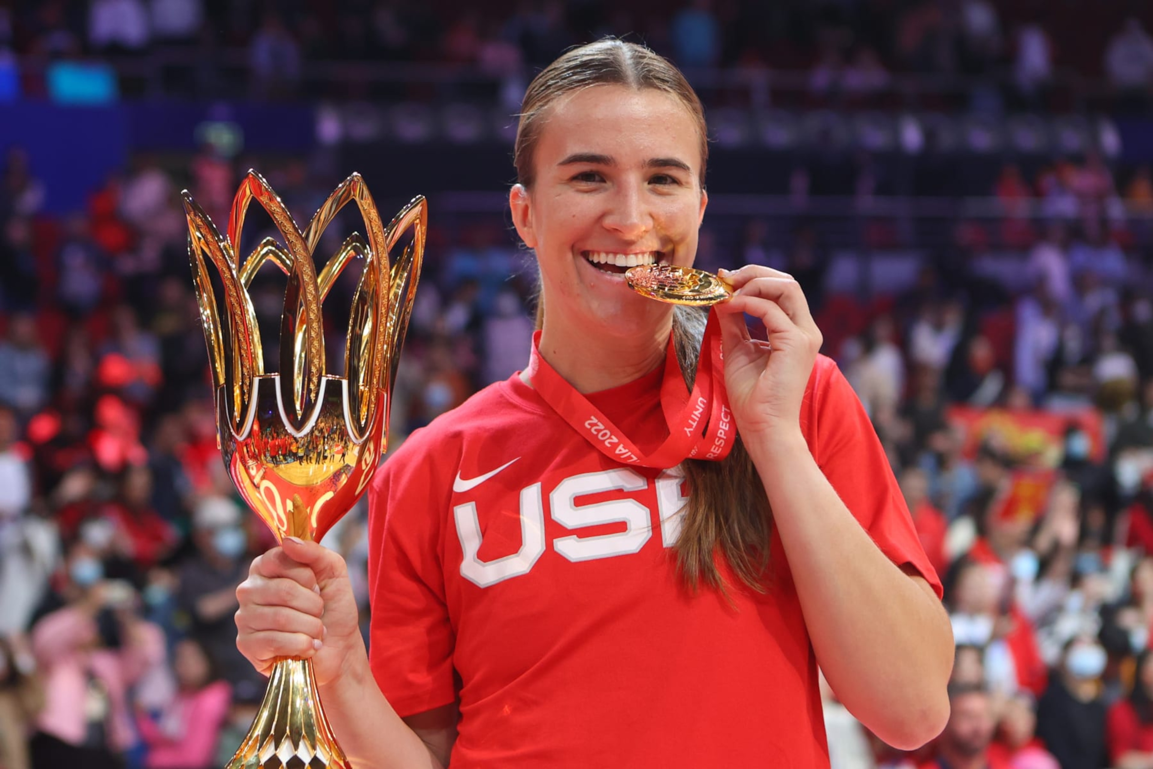 SYDNEY, AUSTRALIA - OCTOBER 01: Sabrina Ionescu of USA celebrates showing off her medal and trophy during the FIBA Women's Basketball World Cup Final between USA and China Ceremony at Sydney Super Dome on October 01, 2022 in Sydney, Australia. (Photo by Pete Dovgan/Speed Media/Icon Sportswire via Getty Images) SYDNEY, AUSTRALIA - OCTOBER 01: Sabrina Ionescu of USA celebrates showing off her medal and trophy during the FIBA Women's Basketball World Cup Final between USA and China Ceremony at Sydney Super Dome on October 01, 2022 in Sydney, Australia. (Photo by Pete Dovgan/Speed Media/Icon Sportswire via Getty Images)