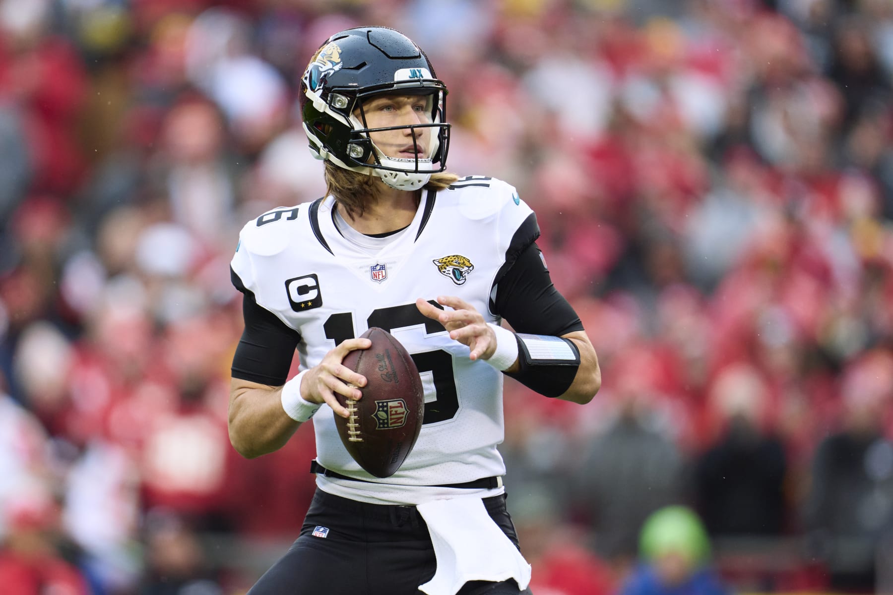KANSAS CITY, MO - JANUARY 21: Trevor Lawrence #16 of the Jacksonville Jaguars drops back to pass against the Kansas City Chiefs during the first half at GEHA Field at Arrowhead Stadium on January 21, 2023 in Kansas City, Missouri. (Photo by Cooper Neill/Getty Images)