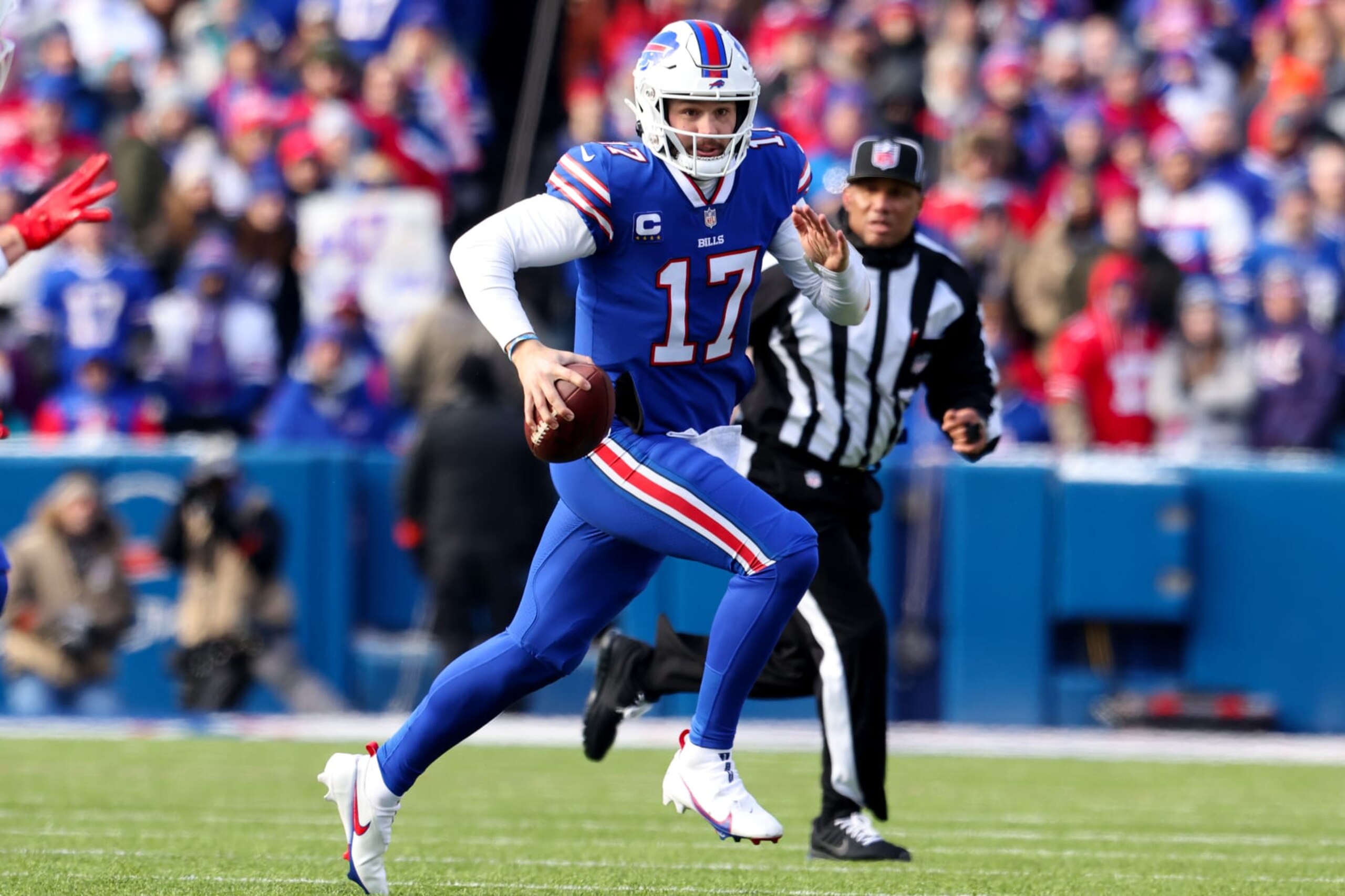 ORCHARD PARK, NEW YORK - JANUARY 15: Josh Allen #17 of the Buffalo Bills scrambles during the first half of the game against the Miami Dolphins in the AFC Wild Card playoff game at Highmark Stadium on January 15, 2023 in Orchard Park, New York. (Photo by Bryan M. Bennett/Getty Images)