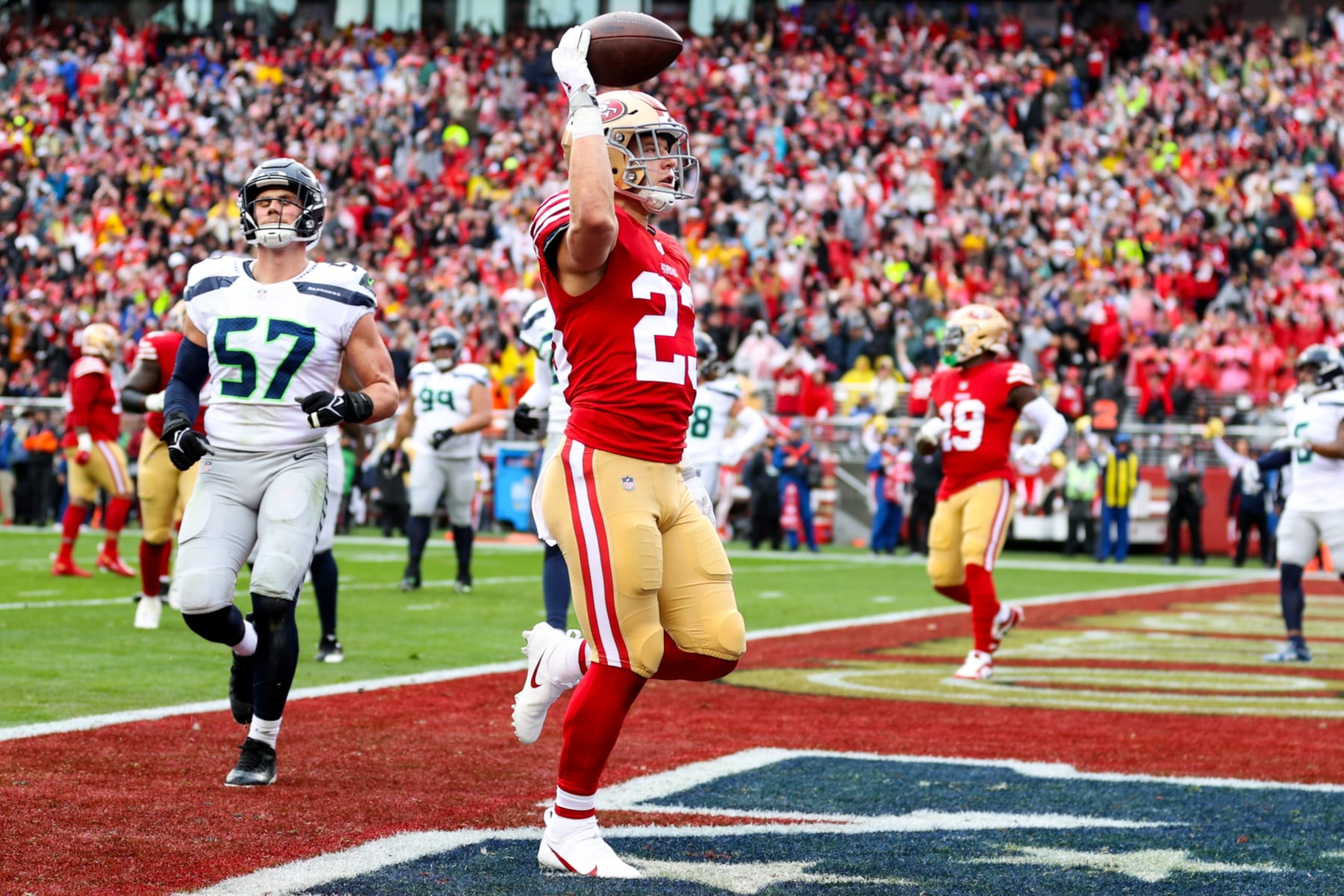 SANTA CLARA, CALIFORNIA - JANUARY 14: Christian McCaffrey #23 of the San Francisco 49ers celebrates after scoring a 3 yard touchdown against the Seattle Seahawks during the first quarter in the NFC Wild Card playoff game at Levi's Stadium on January 14, 2023 in Santa Clara, California. (Photo by Ezra Shaw/Getty Images)