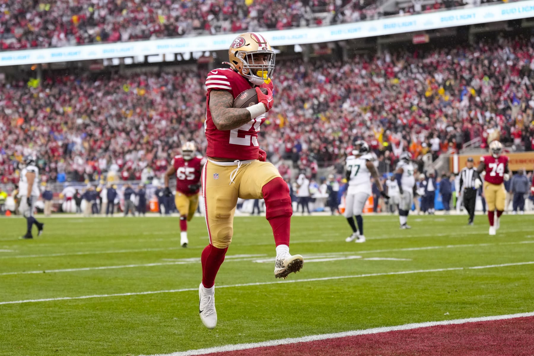 SANTA CLARA, CALIFORNIA - JANUARY 14: Elijah Mitchell #25 of the San Francisco 49ers scores a 7 yard touchdown against the Seattle Seahawks during the fourth quarter in the NFC Wild Card playoff game at Levi's Stadium on January 14, 2023 in Santa Clara, California. (Photo by Thearon W. Henderson/Getty Images)