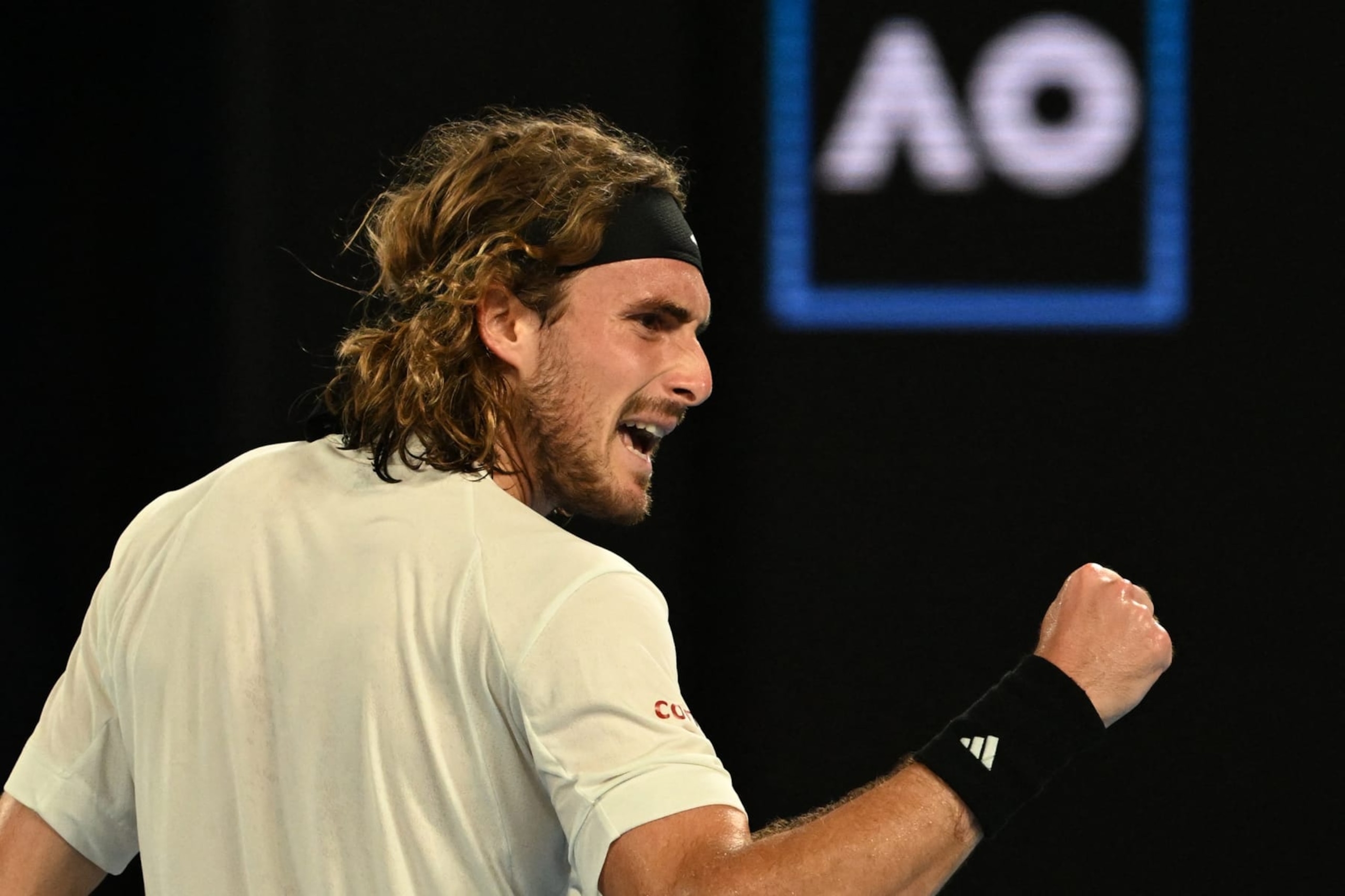 Greece's Stefanos Tsitsipas reacts as he plays against Italy's Jannik Sinner during their men's singles match on day seven of the Australian Open tennis tournament in Melbourne on January 22, 2023. - -- IMAGE RESTRICTED TO EDITORIAL USE - STRICTLY NO COMMERCIAL USE -- (Photo by Paul CROCK / AFP) / -- IMAGE RESTRICTED TO EDITORIAL USE - STRICTLY NO COMMERCIAL USE -- (Photo by PAUL CROCK/AFP via Getty Images)
