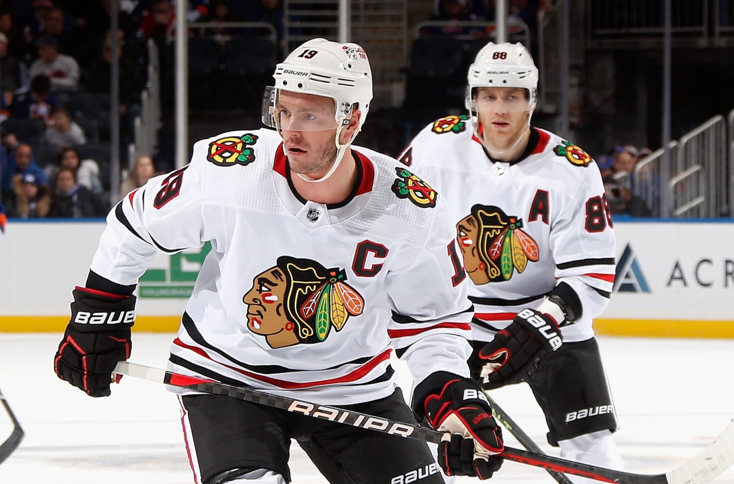ELMONT, NEW YORK - DECEMBER 04: Jonathan Toews #19 and Patrick Kane #88 of the Chicago Blackhawks skates against the New York Islanders during the second period at the UBS Arena on December 04, 2022 in Elmont, New York. (Photo by Bruce Bennett/Getty Images)