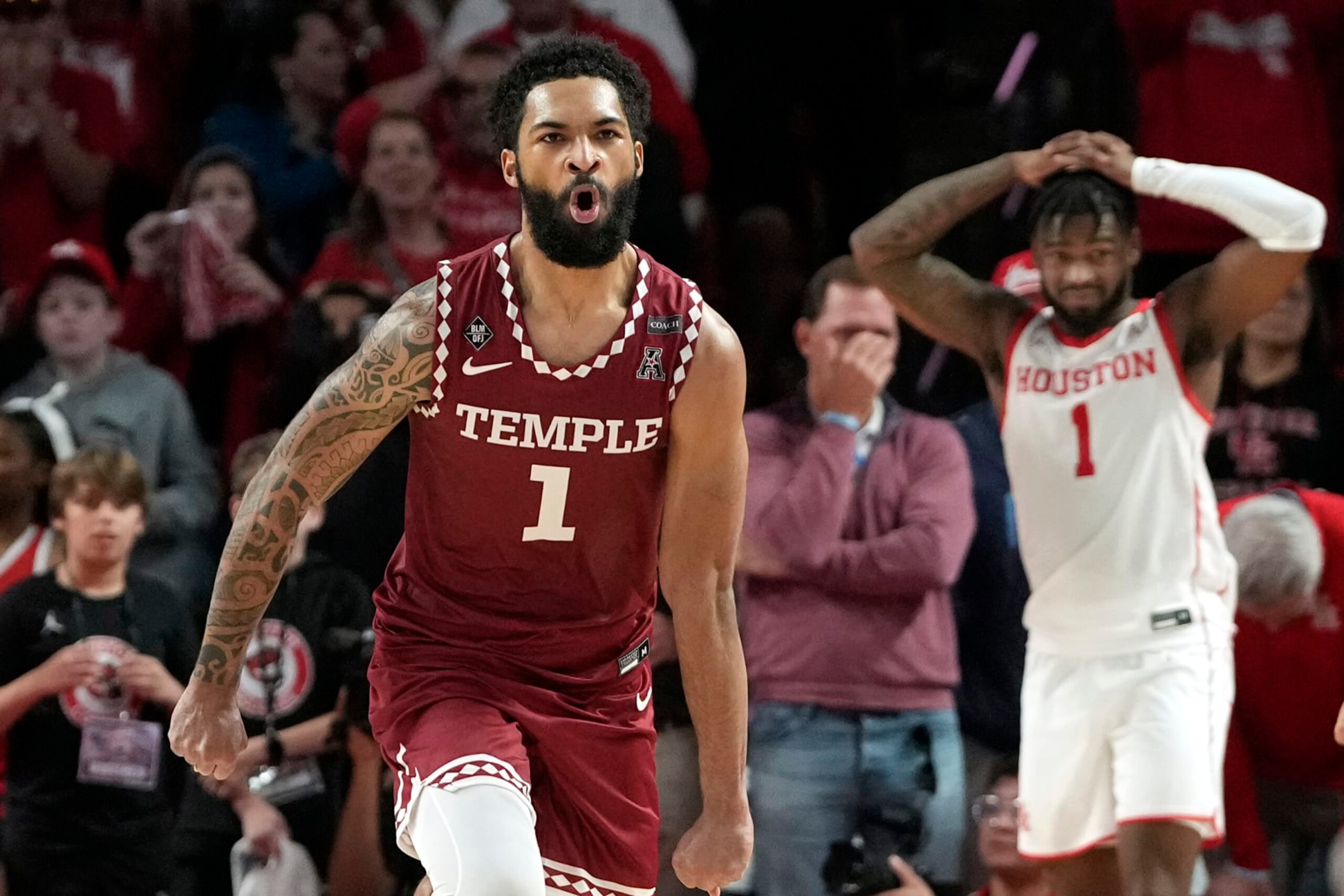 Temple's Damian Dunn, left, celebrates as Houston's Jamal Shead, right, reacts at the end an NCAA college basketball game Sunday, Jan. 22, 2023, in Houston. Temple won 56-55. (AP Photo/David J. Phillip) Temple's Damian Dunn, left, celebrates as Houston's Jamal Shead, right, reacts at the end an NCAA college basketball game Sunday, Jan. 22, 2023, in Houston. Temple won 56-55. (AP Photo/David J. Phillip)
