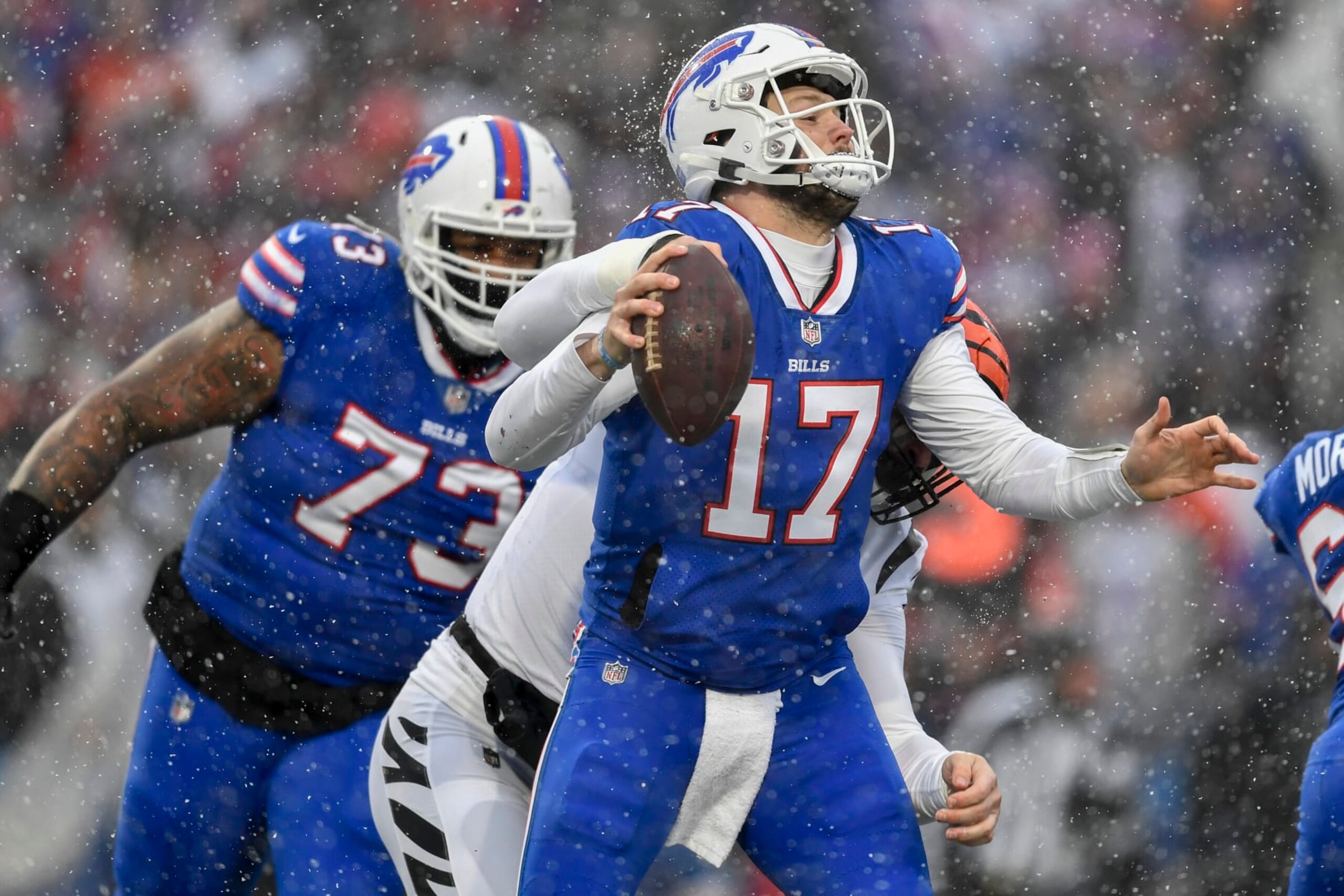 Buffalo Bills quarterback Josh Allen (17) takes a hit from Cincinnati Bengals defensive end Trey Hendrickson (91) during the second quarter of an NFL division round football game, Sunday, Jan. 22, 2023, in Orchard Park, N.Y. (AP Photo/Adrian Kraus)