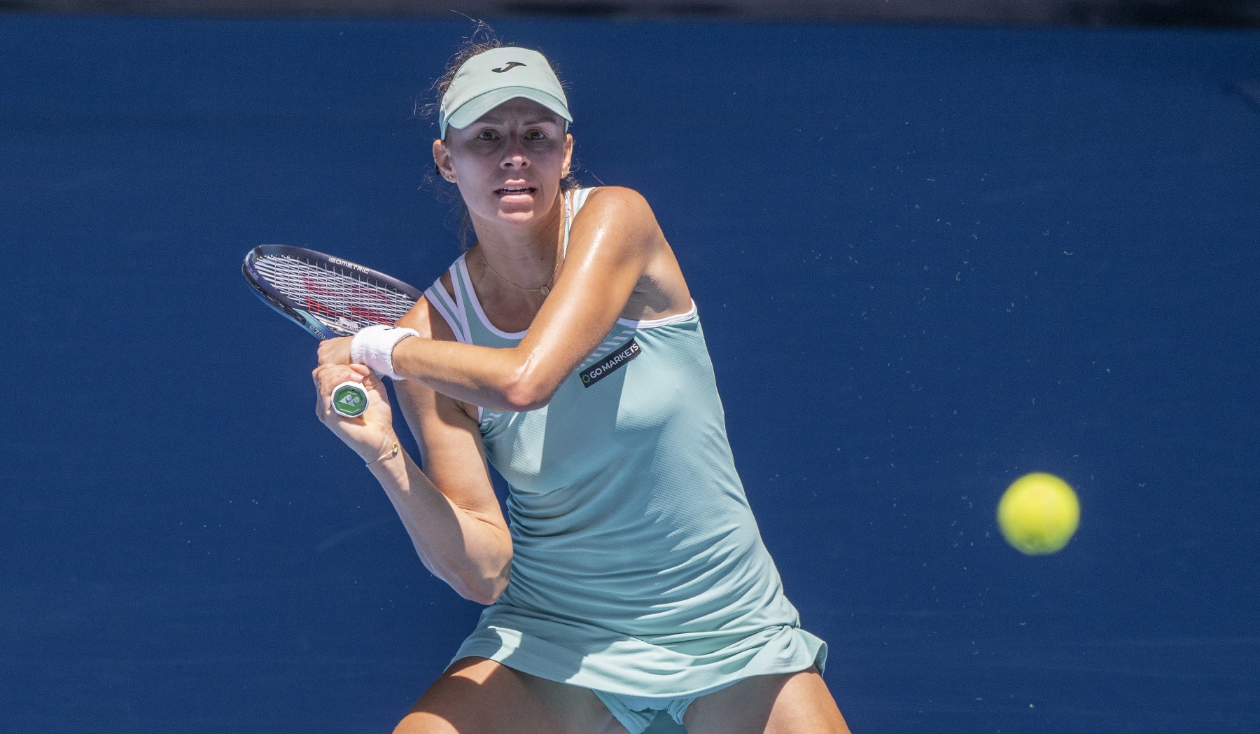 MELBOURNE, AUSTRALIA - JANUARY 23: Magda Linette of Poland plays a backhand the fourth round singles match against Caroline Garcia of France during day eight of the 2023 Australian Open at Melbourne Park on January 23, 2023 in Melbourne, Australia. (Photo by Will Murray/Getty Images)