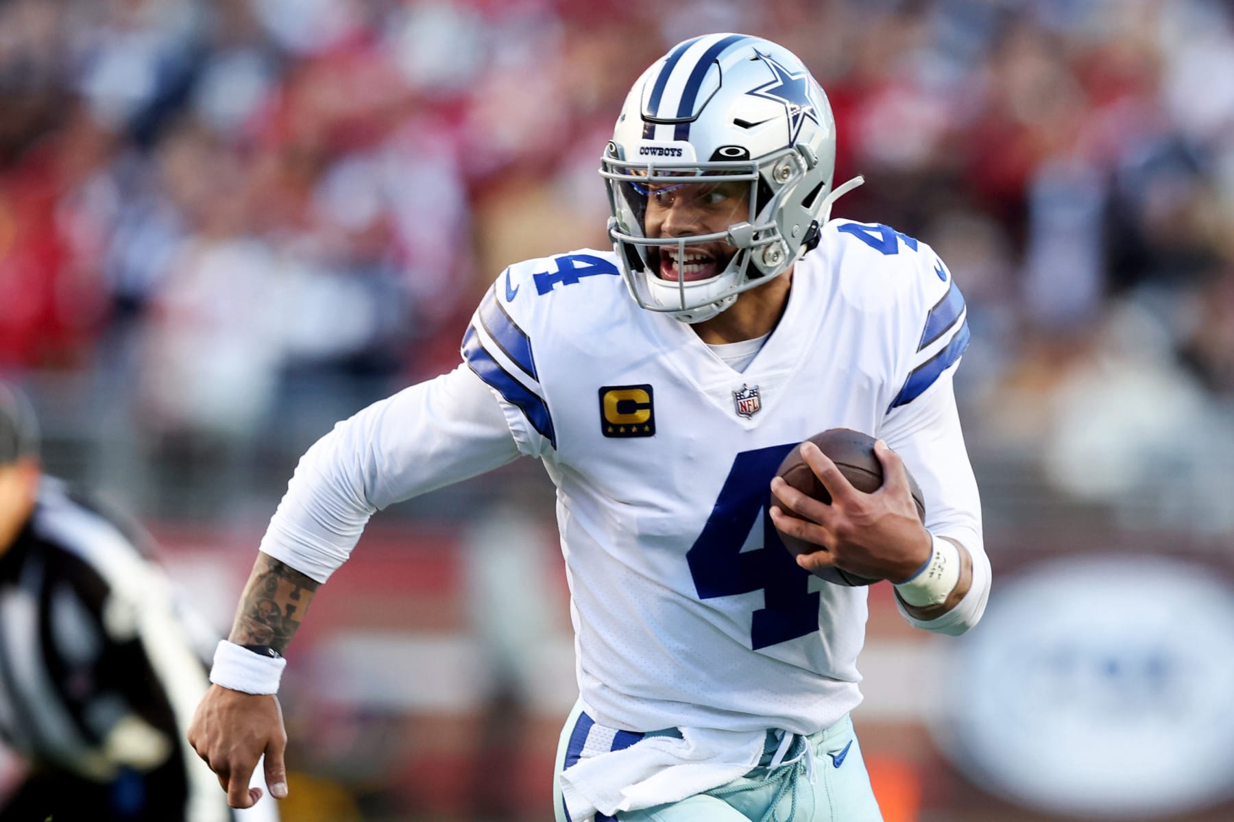 SANTA CLARA, CALIFORNIA - JANUARY 22: Dak Prescott #4 of the Dallas Cowboys scrambles against the San Francisco 49ers during the first half in the NFC Divisional Playoff game at Levi's Stadium on January 22, 2023 in Santa Clara, California. (Photo by Lachlan Cunningham/Getty Images)
