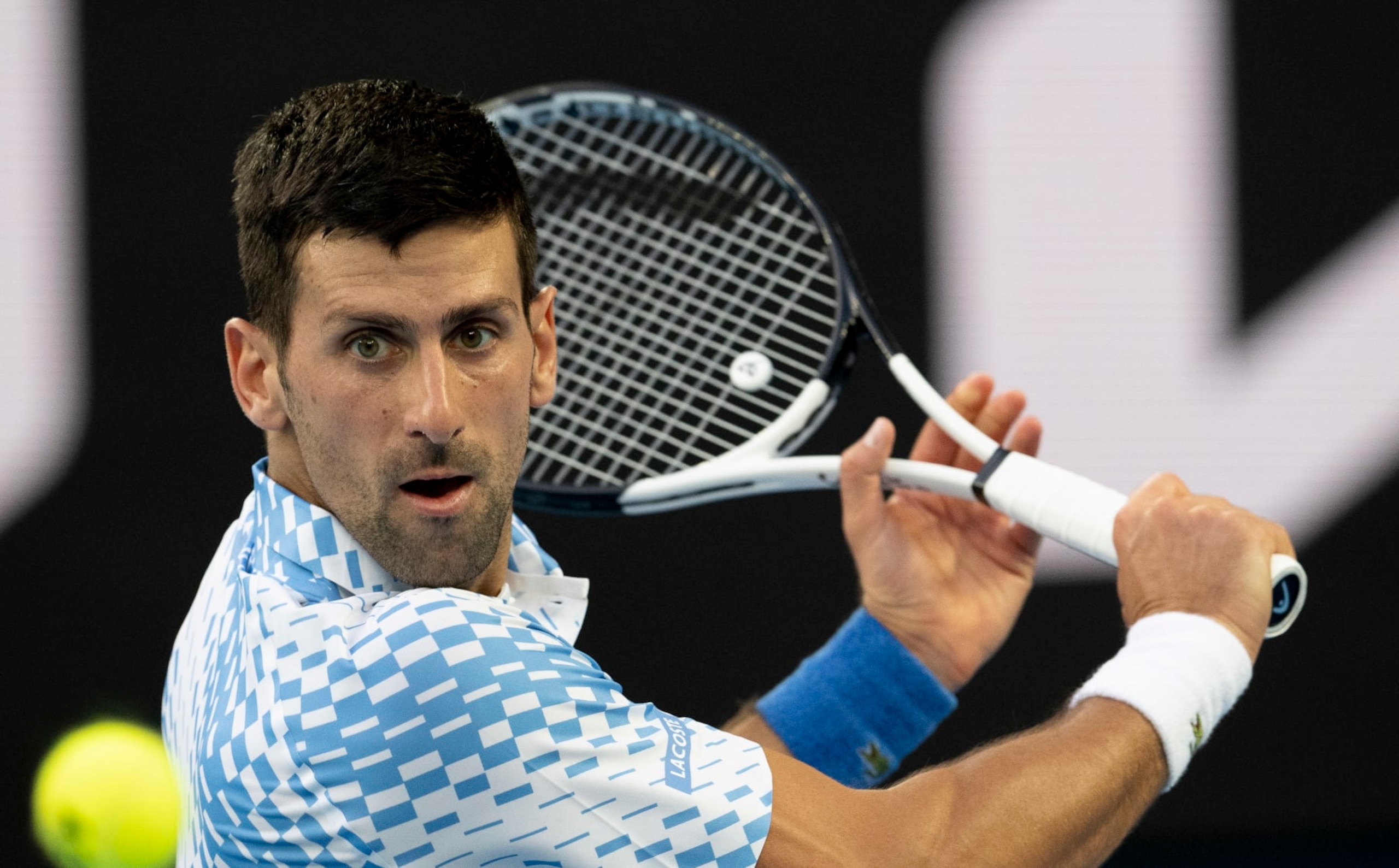 MELBOURNE, AUSTRALIA - JANUARY 23: Novak Djokovic of Serbia plays a backhand in the fourth round singles match against Alex de Minaur of Australia during day eight of the 2023 Australian Open at Melbourne Park on January 23, 2023 in Melbourne, Australia. (Photo by Will Murray/Getty Images)