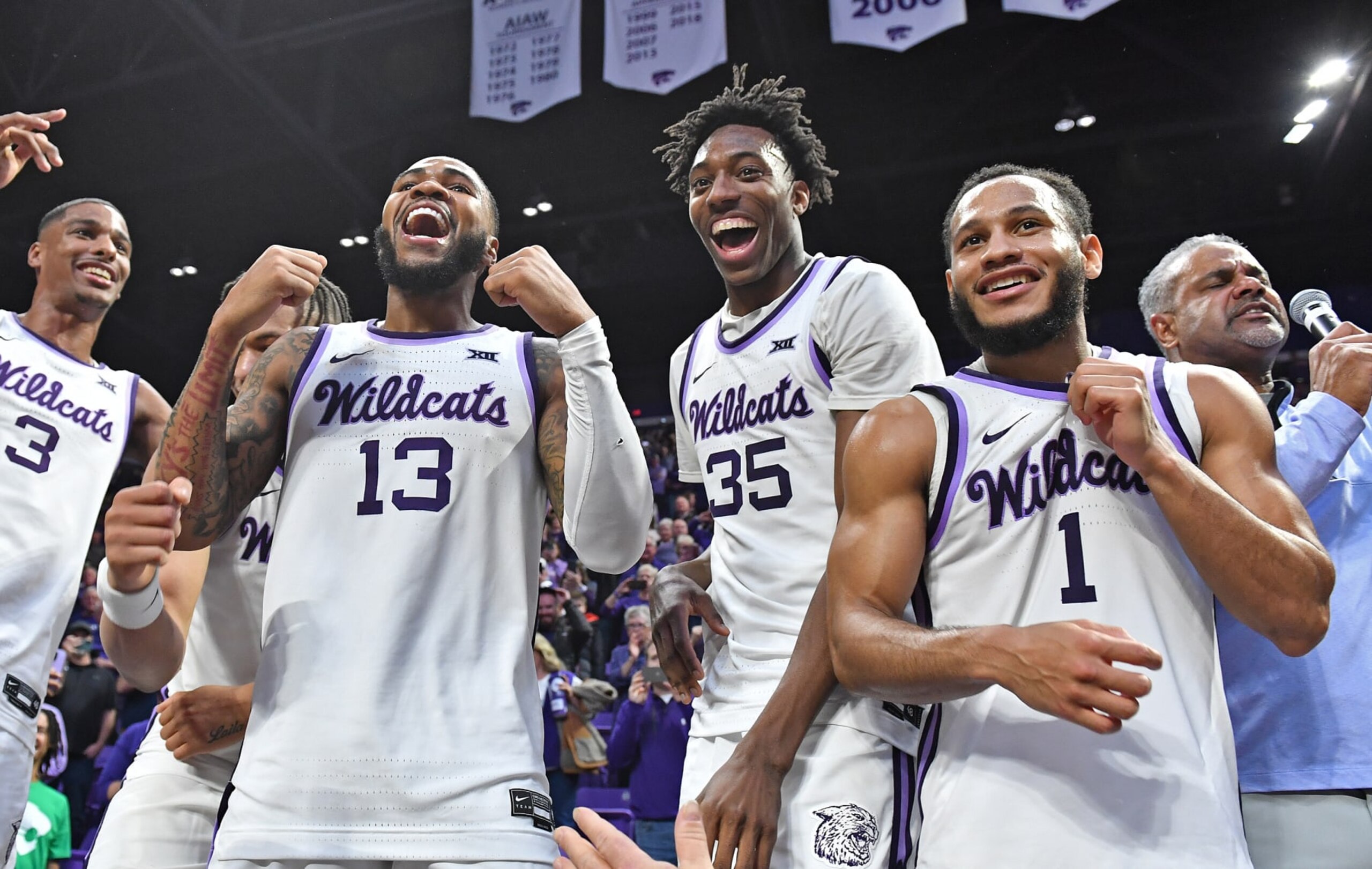 MANHATTAN, KS - JANUARY 17:  Head coach Jerome Tang of the Kansas State Wildcats (R) celebrates with players Markquis Nowell #1, Nae'Qwan Tomlin #35, Desi Sills #13, and David N'Guessan #3 of the Kansas State Wildcats, after beating the Kansas Jayhawks in overtime 83-82 at Bramlage Coliseum on January 17, 2023 in Manhattan, Kansas.  (Photo by Peter Aiken/Getty Images)