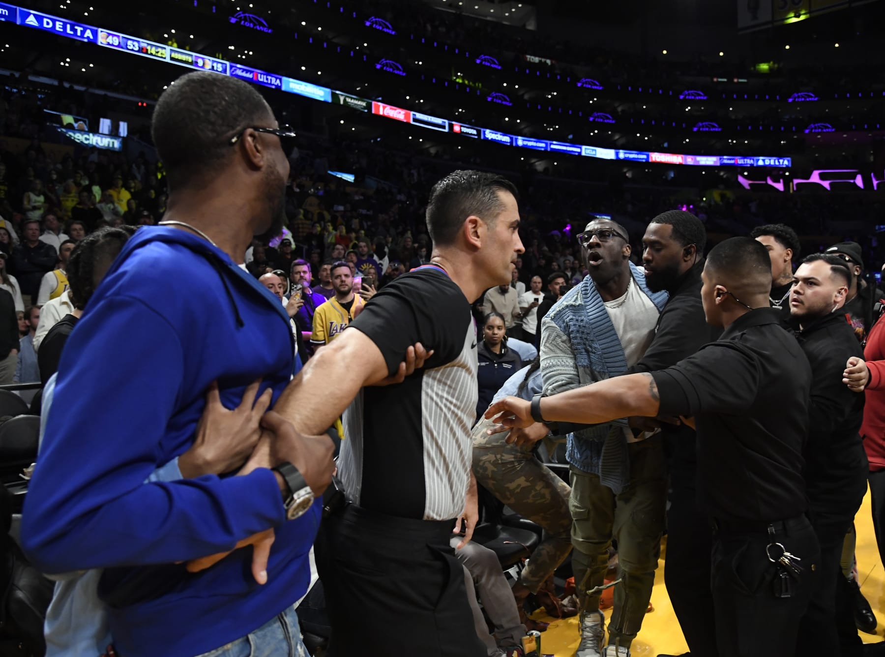 LOS ANGELES, CA - JANUARY 20: Shannon Sharpe and Tee Morant, father of Ja Morant #12 of the Memphis Grizzlies, are separated by security and referees after a verbal altercation between Sharp and Morant during the halftime against the Los Angeles Lakers at Crypto.com Arena on January 20, 2023 in Los Angeles, California. NOTE TO USER: User expressly acknowledges and agrees that, by downloading and or using this photograph, User is consenting to the terms and conditions of the Getty Images License Agreement. (Photo by Kevork Djansezian/Getty Images)