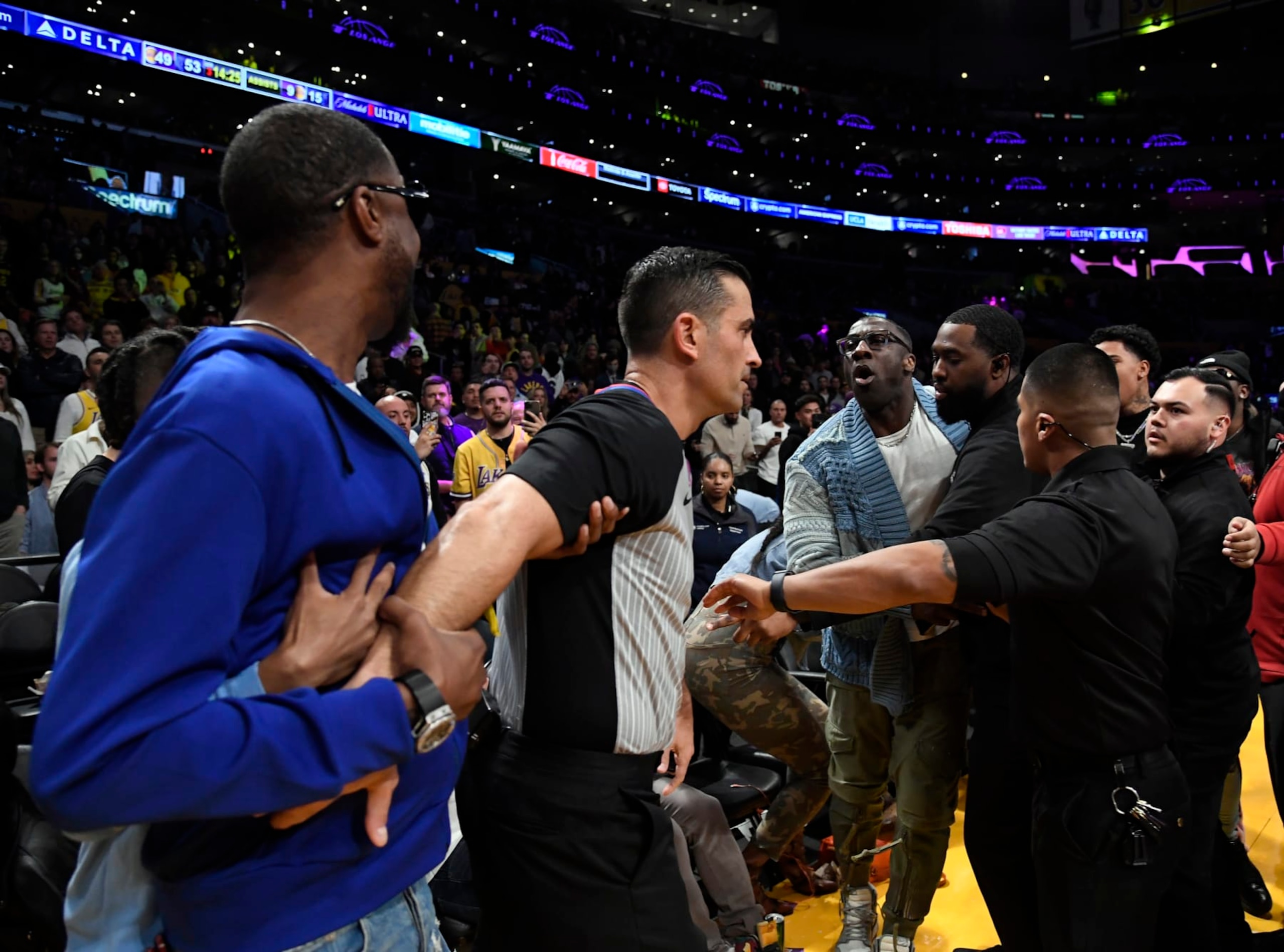 LOS ANGELES, CA - JANUARY 20: Shannon Sharpe and Tee Morant, father of Ja Morant #12 of the Memphis Grizzlies, are separated by security and referees after a verbal altercation between Sharp and Morant during the halftime against the Los Angeles Lakers at Crypto.com Arena on January 20, 2023 in Los Angeles, California. NOTE TO USER: User expressly acknowledges and agrees that, by downloading and or using this photograph, User is consenting to the terms and conditions of the Getty Images License Agreement. (Photo by Kevork Djansezian/Getty Images)
