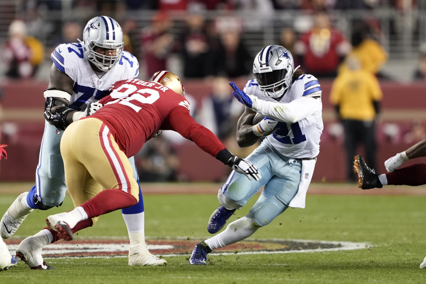SANTA CLARA, CALIFORNIA - JANUARY 22: Ezekiel Elliott #21 of the Dallas Cowboys carries the ball against the San Francisco 49ers during the second half in the NFC Divisional Playoff game at Levi's Stadium on January 22, 2023 in Santa Clara, California. (Photo by Thearon W. Henderson/Getty Images)