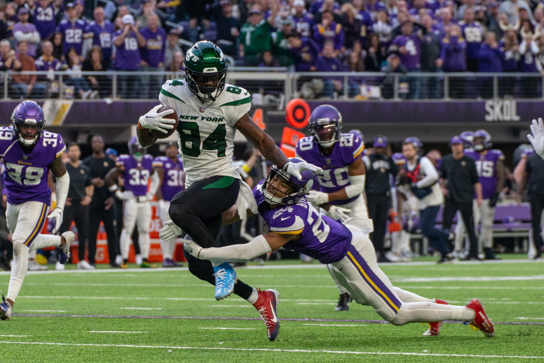 MINNEAPOLIS, MN - DECEMBER 04: New York Jets wide receiver Corey Davis (84) runs with the football while being tackled by Minnesota Vikings safety Camryn Bynum (24) during the NFL game between the New York Jets and the Minnesota Vikings on December 4th, 2022, at U.S. Bank Stadium, in Minneapolis, MN. (Photo by Bailey Hillesheim/Icon Sportswire via Getty Images)