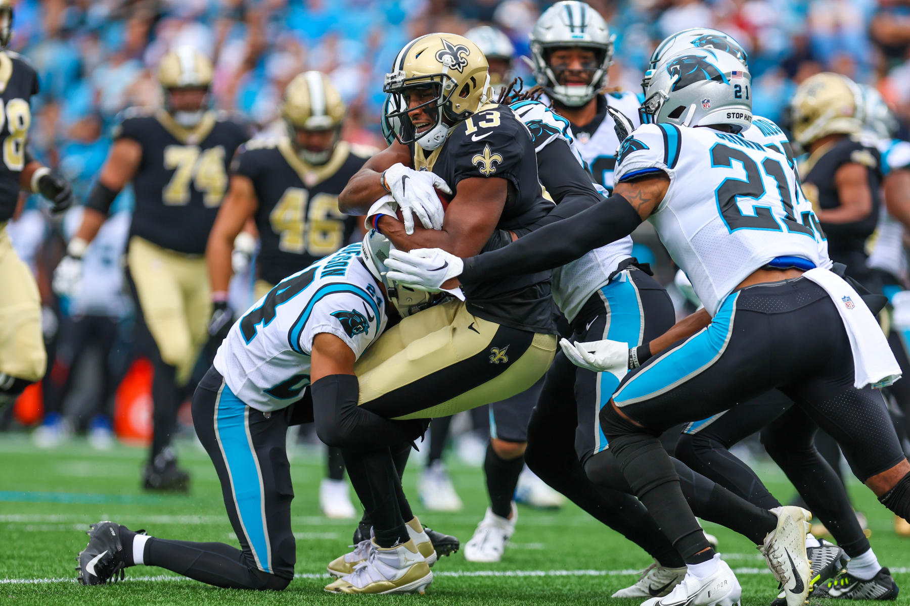 CHARLOTTE, NC - SEPTEMBER 25: Michael Thomas (13) of the New Orleans Saints tries to stay on his feet as he gets tackled by a slew of Carolina Panthers defenders during a football game between the Carolina Panthers and the New Orleans Saints on Sep 25, 2022, at Bank of America Stadium in Charlotte, NC. (Photo by David Jensen/Icon Sportswire via Getty Images)
