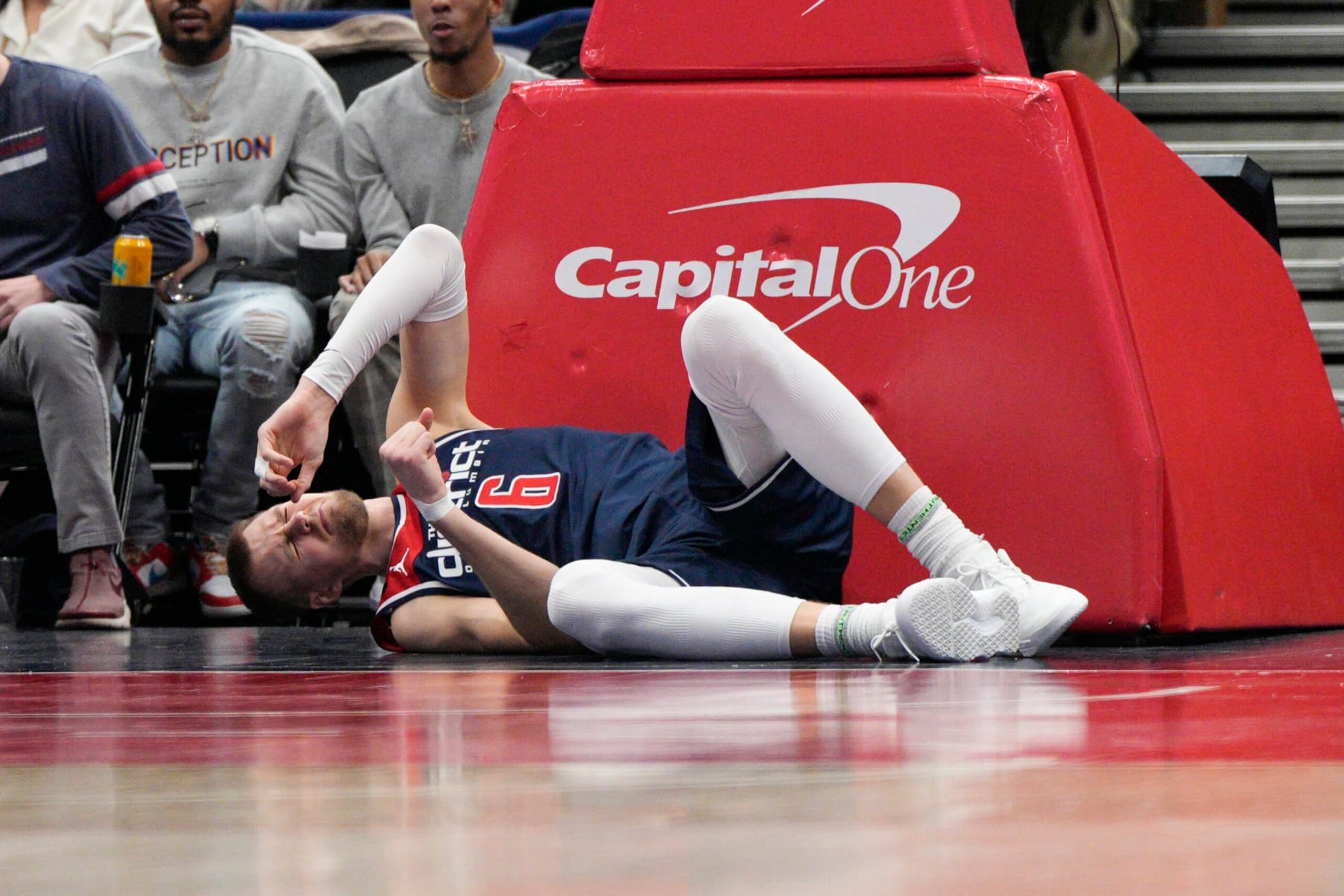 Washington Wizards center Kristaps Porzingis (6) lies on the floor after being injured during the second half of an NBA basketball game against the Orlando Magic, Saturday, Jan. 21, 2023, in Washington. Porzingis left the game and did not return. (AP Photo/Jess Rapfogel)