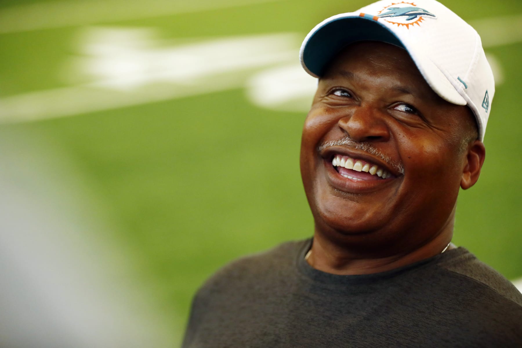 Miami Dolphins assistant head coach Jim Caldwell laughs during NFL rookie camp on Thursday, May 9, 2019, in Davie, Fla. (AP Photo/Brynn Anderson)