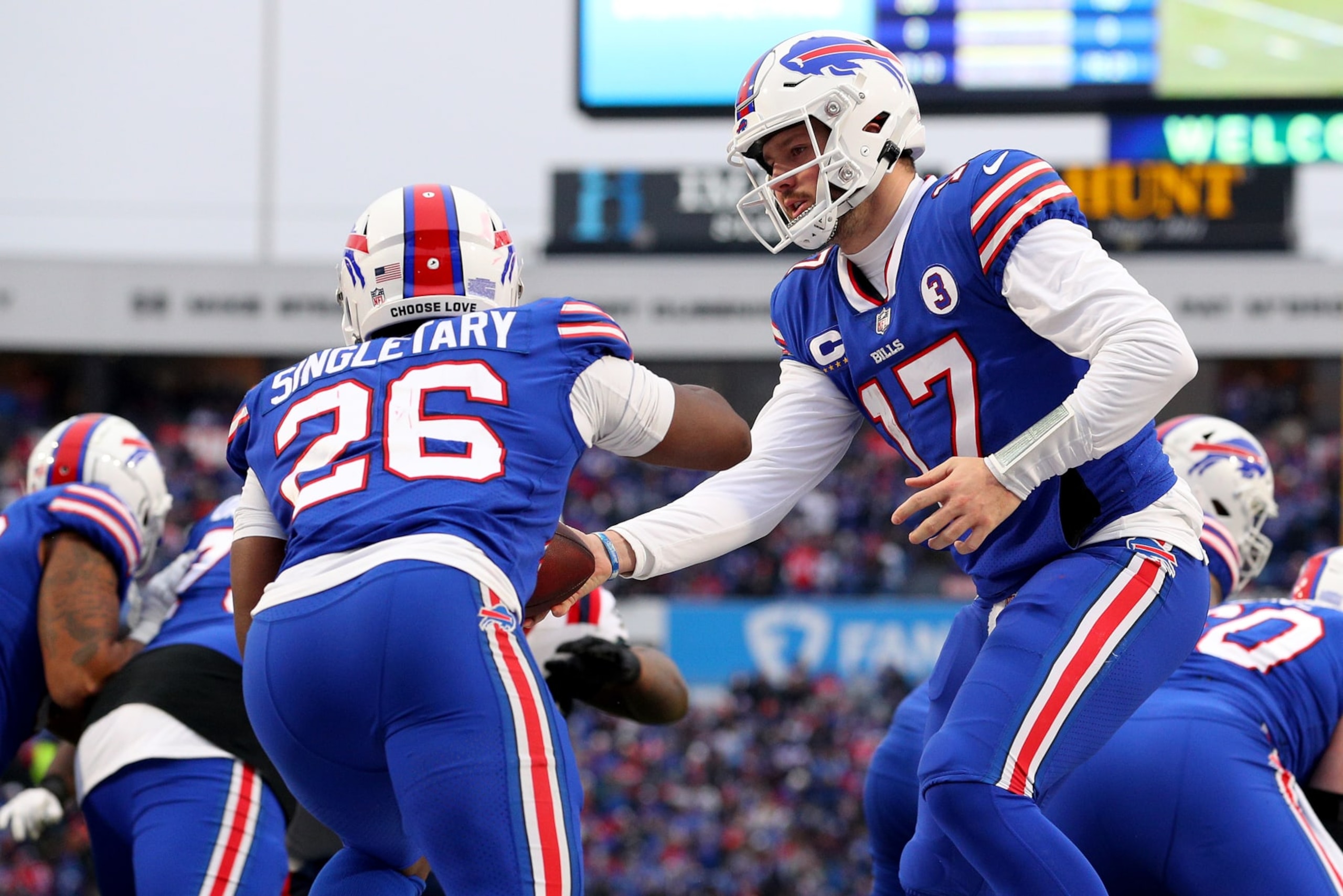 ORCHARD PARK, NEW YORK - JANUARY 08: Devin Singletary #26 takes a handoff from Josh Allen #17 of the Buffalo Bills during the third quarter against the New England Patriots at Highmark Stadium on January 08, 2023 in Orchard Park, New York. (Photo by Bryan Bennett/Getty Images)