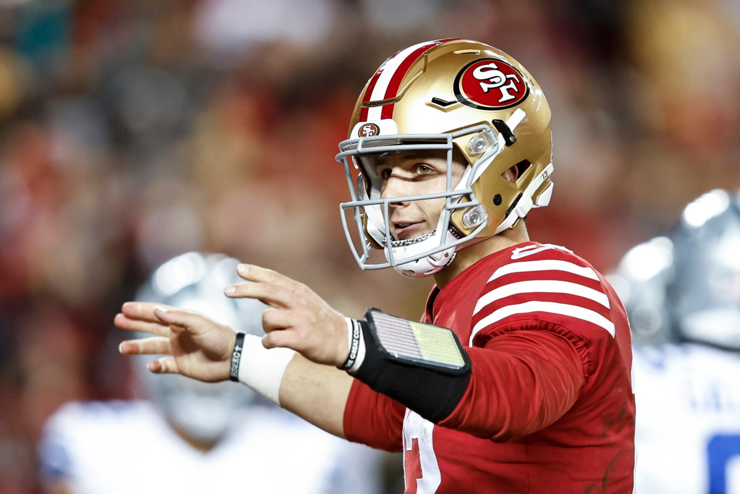 SANTA CLARA, CALIFORNIA - JANUARY 22: Brock Purdy #13 of the San Francisco 49ers celebrates after handing off the ball for a touchdown during an NFL divisional round playoff football game between the San Francisco 49ers and the Dallas Cowboys at Levi's Stadium on January 22, 2023 in Santa Clara, California. (Photo by Michael Owens/Getty Images)