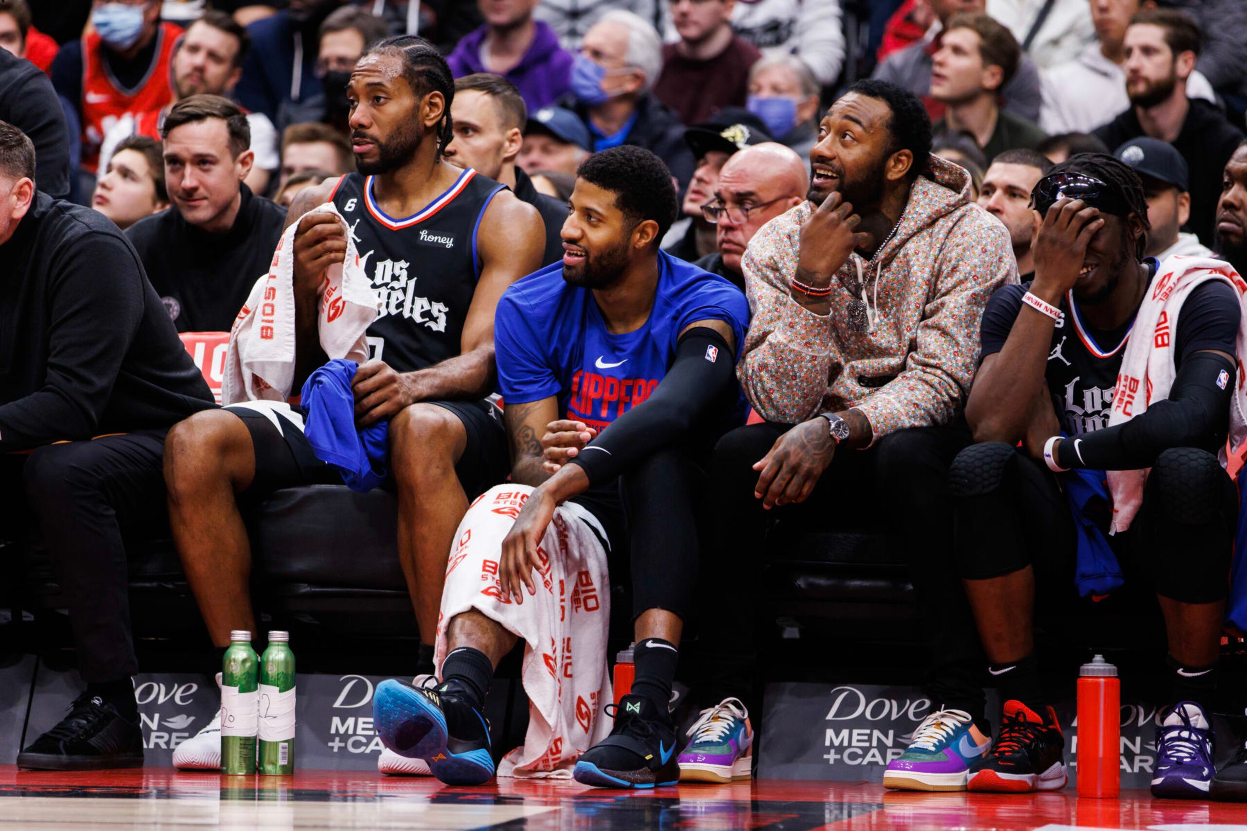 TORONTO, ON - DECEMBER 27: Kawhi Leonard #2, Paul George #13, John Wall #11 and Reggie Jackson #1 of the LA Clippers sit on the bench during the second half of their NBA game against the Toronto Raptors at Scotiabank Arena on December 27, 2022 in Toronto, Canada. NOTE TO USER: User expressly acknowledges and agrees that, by downloading and or using this photograph, User is consenting to the terms and conditions of the Getty Images License Agreement. (Photo by Cole Burston/Getty Images)