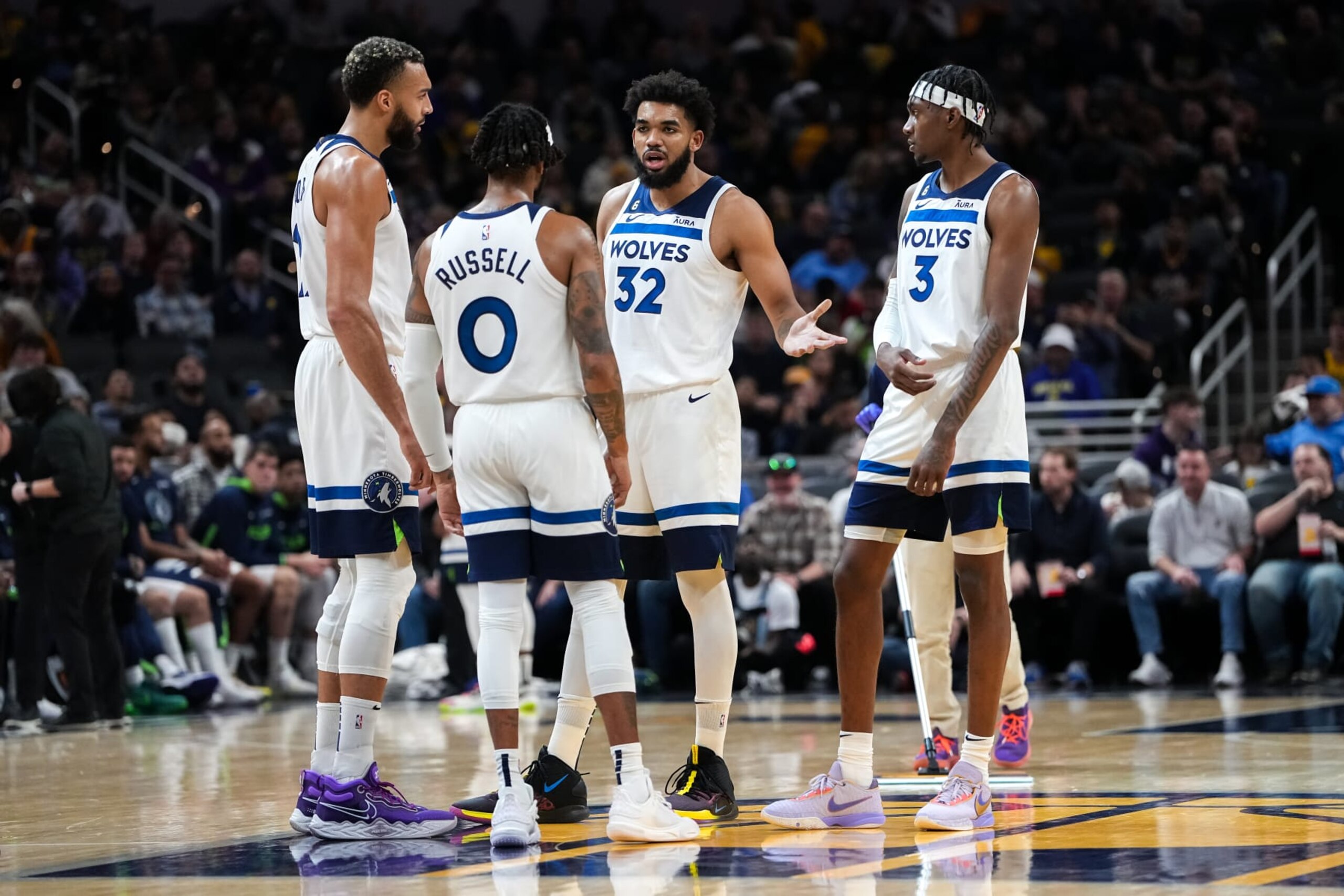INDIANAPOLIS, INDIANA - NOVEMBER 23: Rudy Gobert #27, D'Angelo Russell #0, Karl-Anthony Towns #32, and Jaden McDaniels #3 of the Minnesota Timberwolves meet in the third quarter against the Indiana Pacers at Gainbridge Fieldhouse on November 23, 2022 in Indianapolis, Indiana. NOTE TO USER: User expressly acknowledges and agrees that, by downloading and or using this photograph, User is consenting to the terms and conditions of the Getty Images License Agreement. (Photo by Dylan Buell/Getty Images)