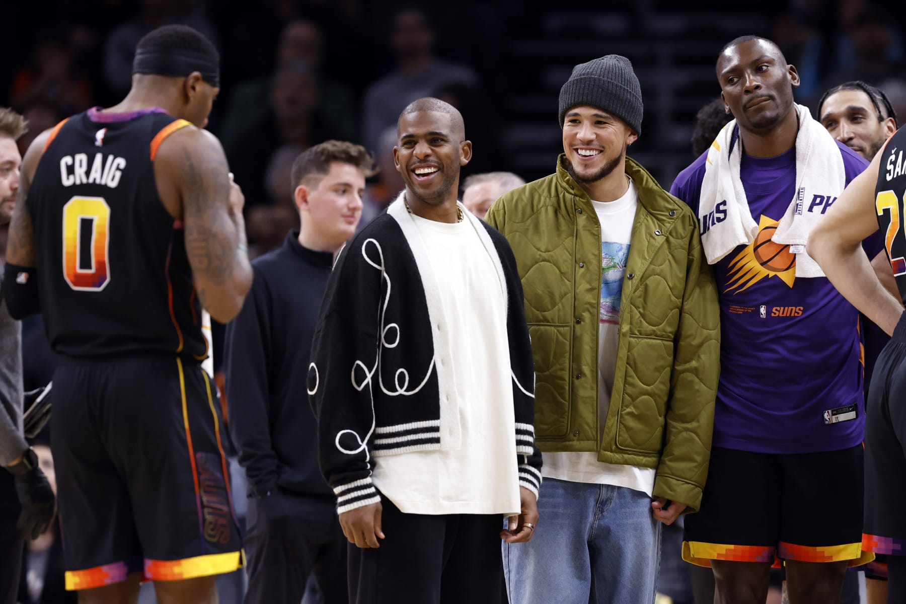 PHOENIX, ARIZONA - JANUARY 19: Chris Paul of the Phoenix Suns (L) and Devin Booker  smile during the game against the Brooklyn Nets at Footprint Center on January 19, 2023 in Phoenix, Arizona. The Suns beat the Nets 117-112. NOTE TO USER: User expressly acknowledges and agrees that,  by downloading and or using this photograph,  User is consenting to the terms and conditions of the Getty Images License Agreement. (Photo by Chris Coduto/Getty Images)