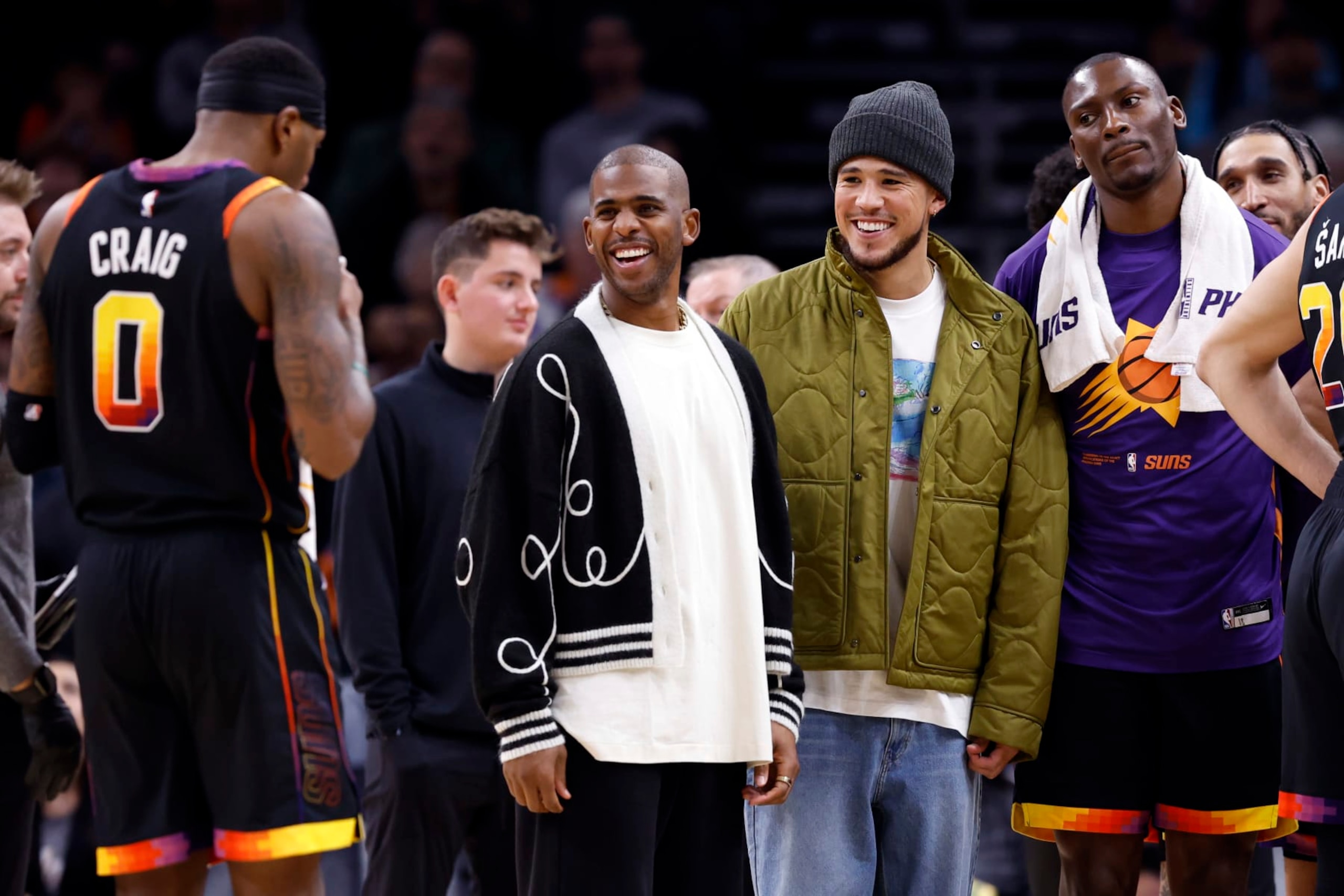 PHOENIX, ARIZONA - JANUARY 19: Chris Paul of the Phoenix Suns (L) and Devin Booker  smile during the game against the Brooklyn Nets at Footprint Center on January 19, 2023 in Phoenix, Arizona. The Suns beat the Nets 117-112. NOTE TO USER: User expressly acknowledges and agrees that,  by downloading and or using this photograph,  User is consenting to the terms and conditions of the Getty Images License Agreement. (Photo by Chris Coduto/Getty Images)