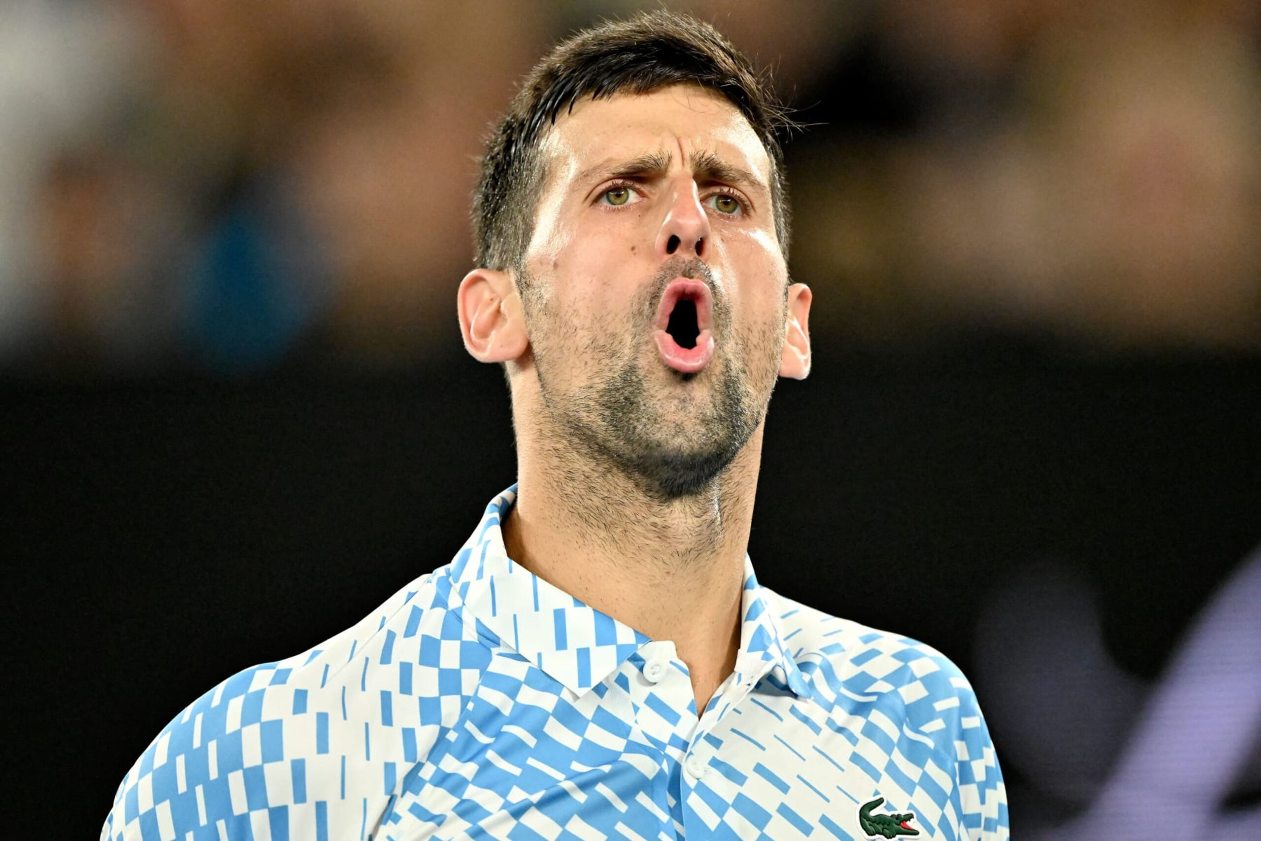 Serbia's Novak Djokovic reacts on a point against Russia's Andrey Rublev during their men's singles quarter-final match on day ten of the Australian Open tennis tournament in Melbourne on January 25, 2023. - -- IMAGE RESTRICTED TO EDITORIAL USE - STRICTLY NO COMMERCIAL USE -- (Photo by Paul CROCK / AFP) / -- IMAGE RESTRICTED TO EDITORIAL USE - STRICTLY NO COMMERCIAL USE -- (Photo by PAUL CROCK/AFP via Getty Images)