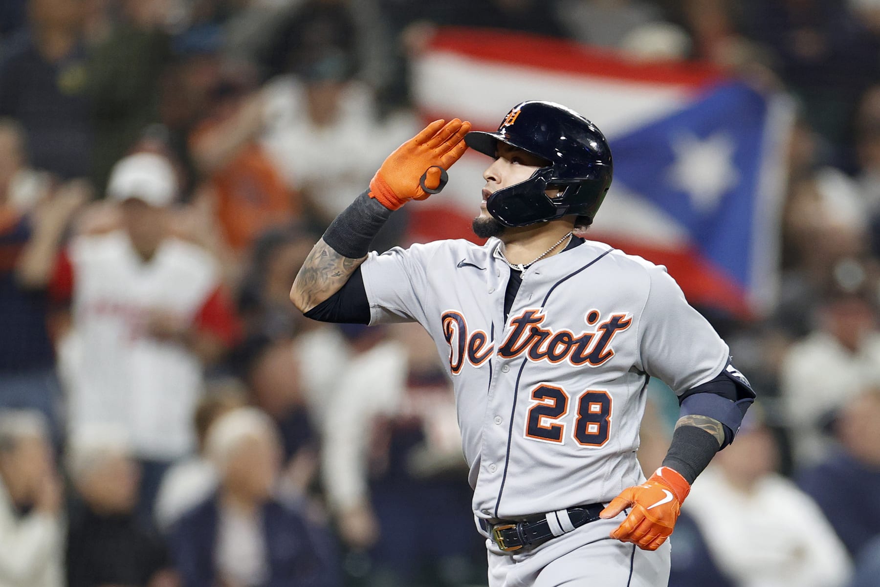 SEATTLE, WASHINGTON - OCTOBER 03: Javier Baez #28 of the Detroit Tigers reacts as a fan  waves a Puerto Rican flag after his two-run home run against the Seattle Mariners during the third inning at T-Mobile Park on October 03, 2022 in Seattle, Washington. (Photo by Steph Chambers/Getty Images)