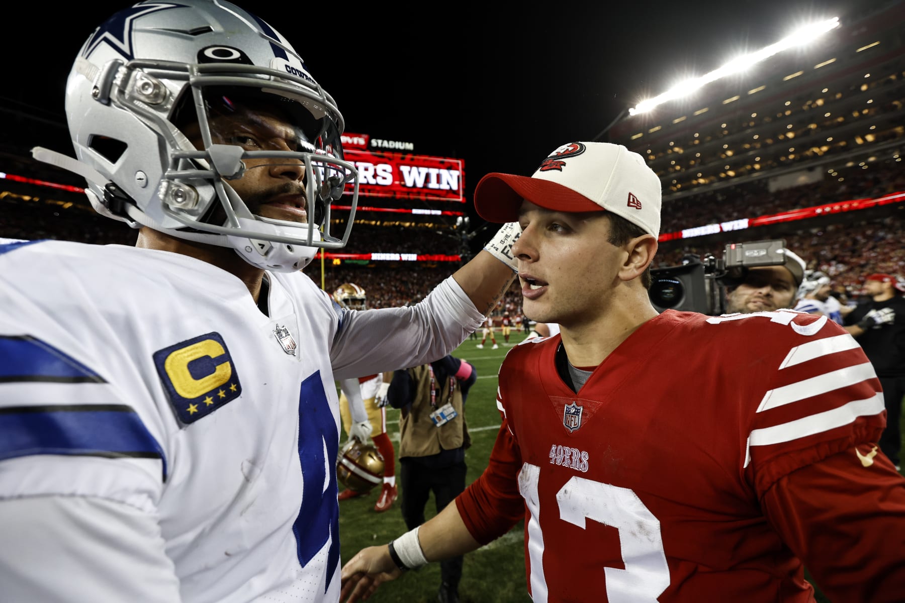 SANTA CLARA, CALIFORNIA - JANUARY 22: Brock Purdy #13 of the San Francisco 49ers meets with Dak Prescott #4 of the Dallas Cowboys following an NFL divisional round playoff football game between the San Francisco 49ers and the Dallas Cowboys at Levi's Stadium on January 22, 2023 in Santa Clara, California. (Photo by Michael Owens/Getty Images)