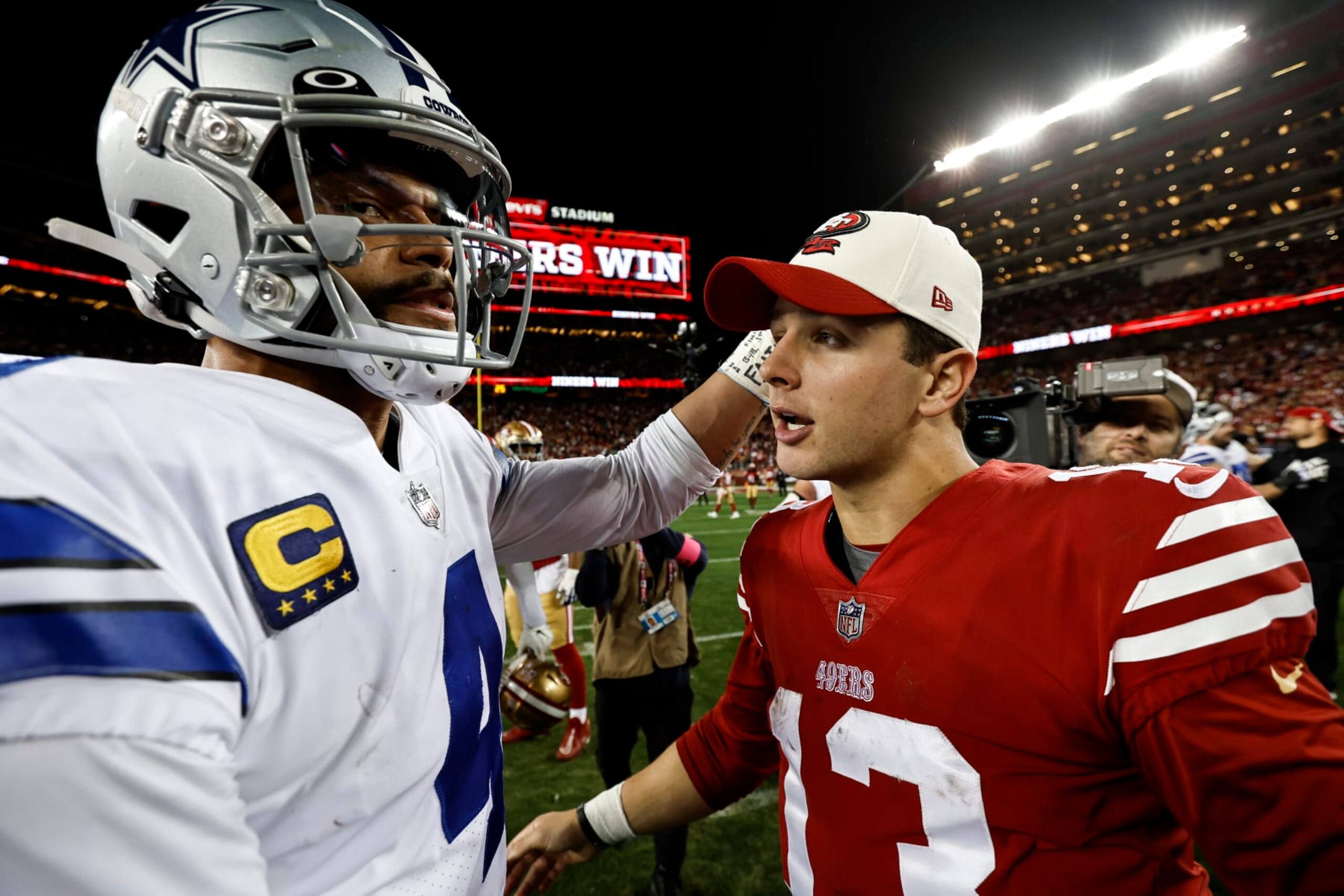 SANTA CLARA, CALIFORNIA - JANUARY 22: Brock Purdy #13 of the San Francisco 49ers meets with Dak Prescott #4 of the Dallas Cowboys following an NFL divisional round playoff football game between the San Francisco 49ers and the Dallas Cowboys at Levi's Stadium on January 22, 2023 in Santa Clara, California. (Photo by Michael Owens/Getty Images) SANTA CLARA, CALIFORNIA - JANUARY 22: Brock Purdy #13 of the San Francisco 49ers meets with Dak Prescott #4 of the Dallas Cowboys following an NFL divisional round playoff football game between the San Francisco 49ers and the Dallas Cowboys at Levi's Stadium on January 22, 2023 in Santa Clara, California. (Photo by Michael Owens/Getty Images)
