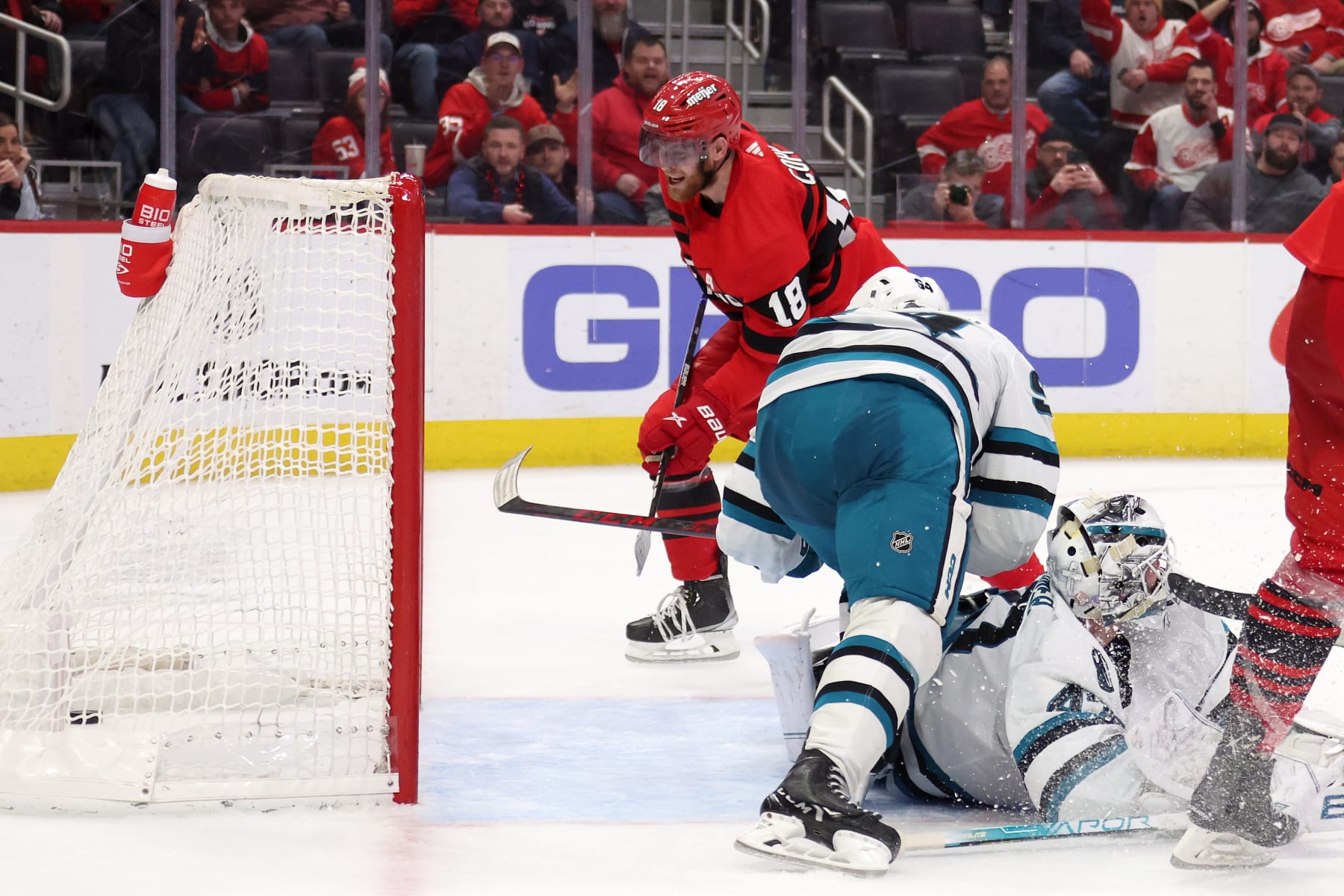 DETROIT, MICHIGAN - JANUARY 24: Andrew Copp #18 of the Detroit Red Wings scores a overtime goal past James Reimer #47 of the San Jose Sharks for a 3-2 win at Little Caesars Arena on January 24, 2023 in Detroit, Michigan. (Photo by Gregory Shamus/Getty Images)