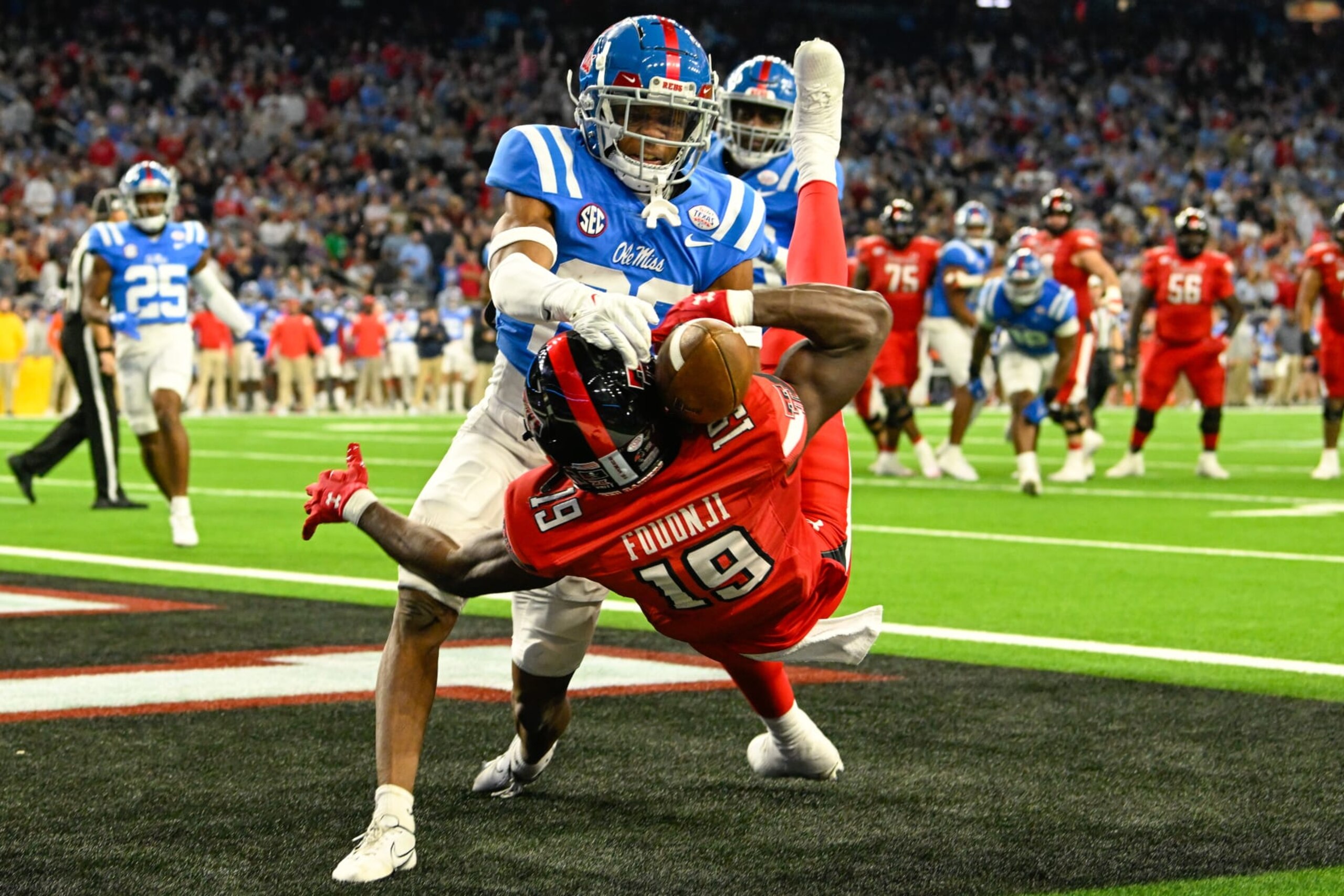 HOUSTON, TX - DECEMBER 28: Texas Tech Red Raiders wide receiver Loic Fouonji (19) attempts to pin the ball to his helmet for a reception as Mississippi Rebels cornerback Davison Igbinosun (20) defends during the TaxAct Texas Bowl between the Texas Tech Red Raiders and Ole Miss Rebels at NRG Stadium on December 28, 2022 in Houston, Texas. (Photo by Ken Murray/Icon Sportswire via Getty Images)