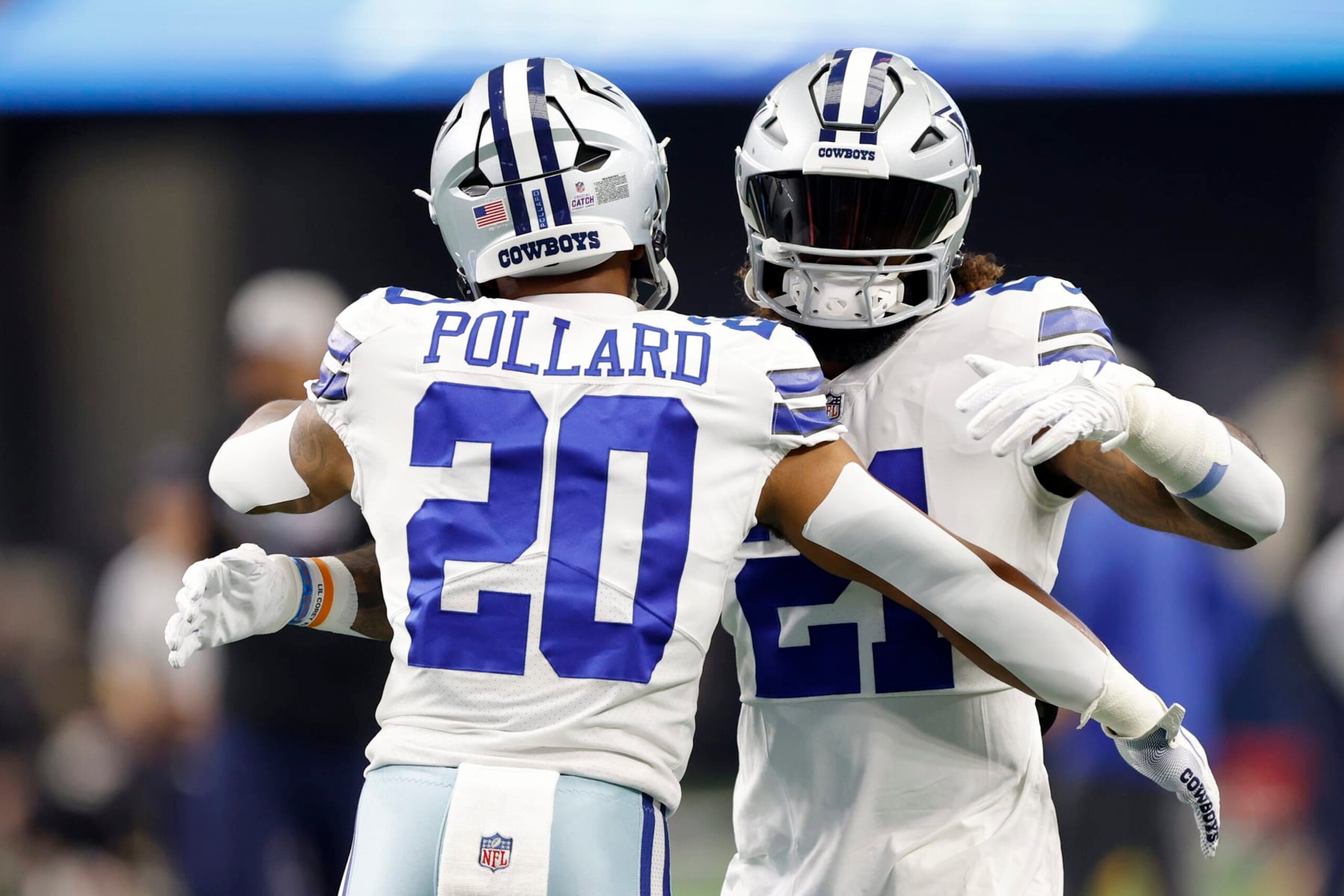 ARLINGTON, TEXAS - OCTOBER 02: Tony Pollard #20 of the Dallas Cowboys and Ezekiel Elliott #21 of the Dallas Cowboys embrace during warm ups against the Washington Commanders at AT&T Stadium on October 02, 2022 in Arlington, Texas. (Photo by Wesley Hitt/Getty Images)