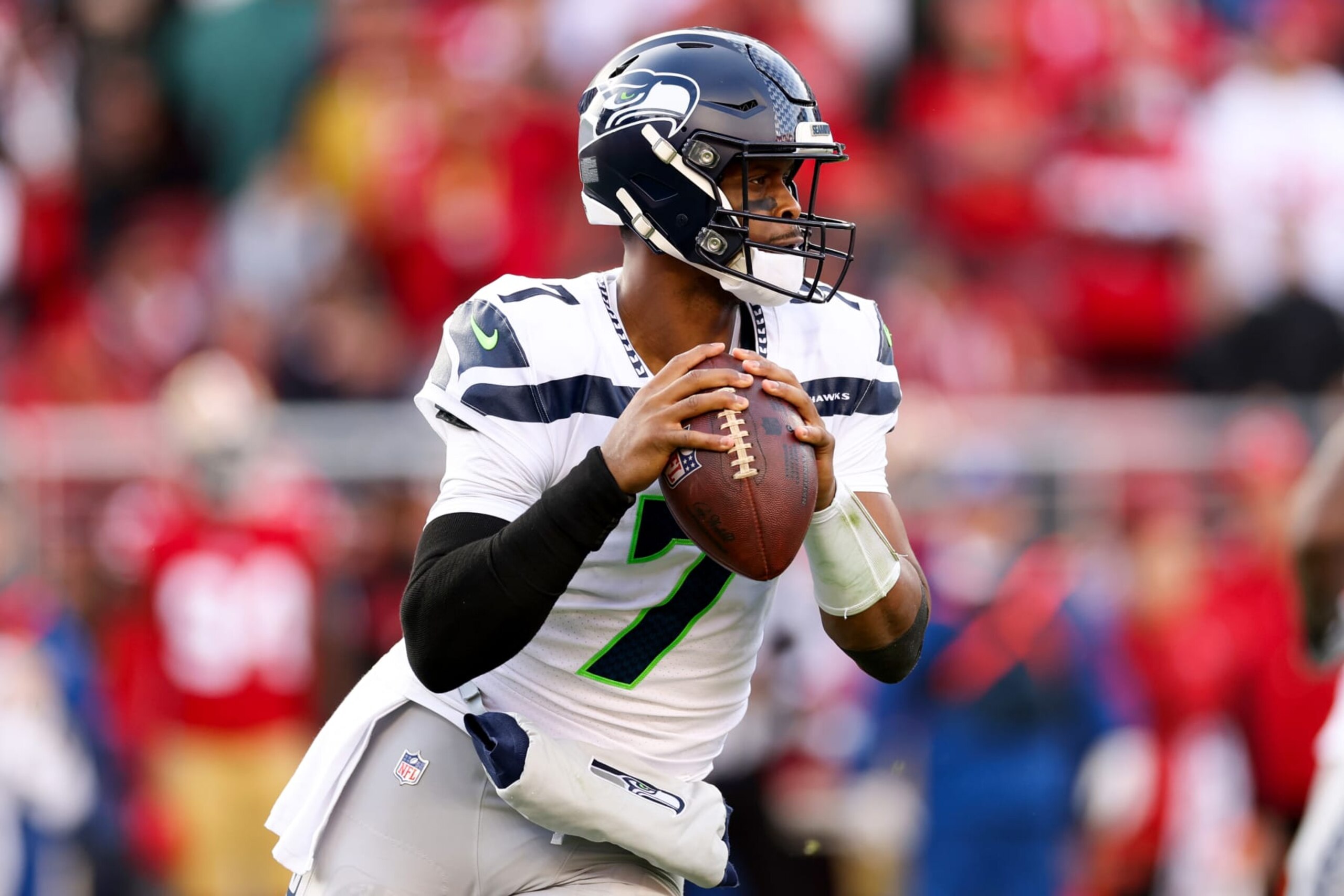 SANTA CLARA, CALIFORNIA - JANUARY 14: Geno Smith #7 of the Seattle Seahawks looks to pass against the San Francisco 49ers during the first half of the game in the NFC Wild Card playoff game at Levi's Stadium on January 14, 2023 in Santa Clara, California. (Photo by Ezra Shaw/Getty Images)