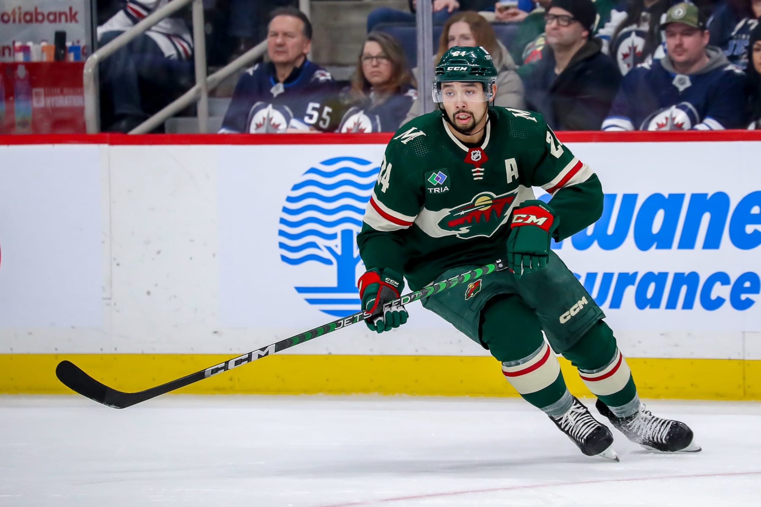 WINNIPEG, CANADA - DECEMBER 27: Matt Dumba #24 of the Minnesota Wild keeps an eye on the play during second period action against the Winnipeg Jets at the Canada Life Centre on December 27, 2022 in Winnipeg, Manitoba, Canada. (Photo by Darcy Finley/NHLI via Getty Images)
