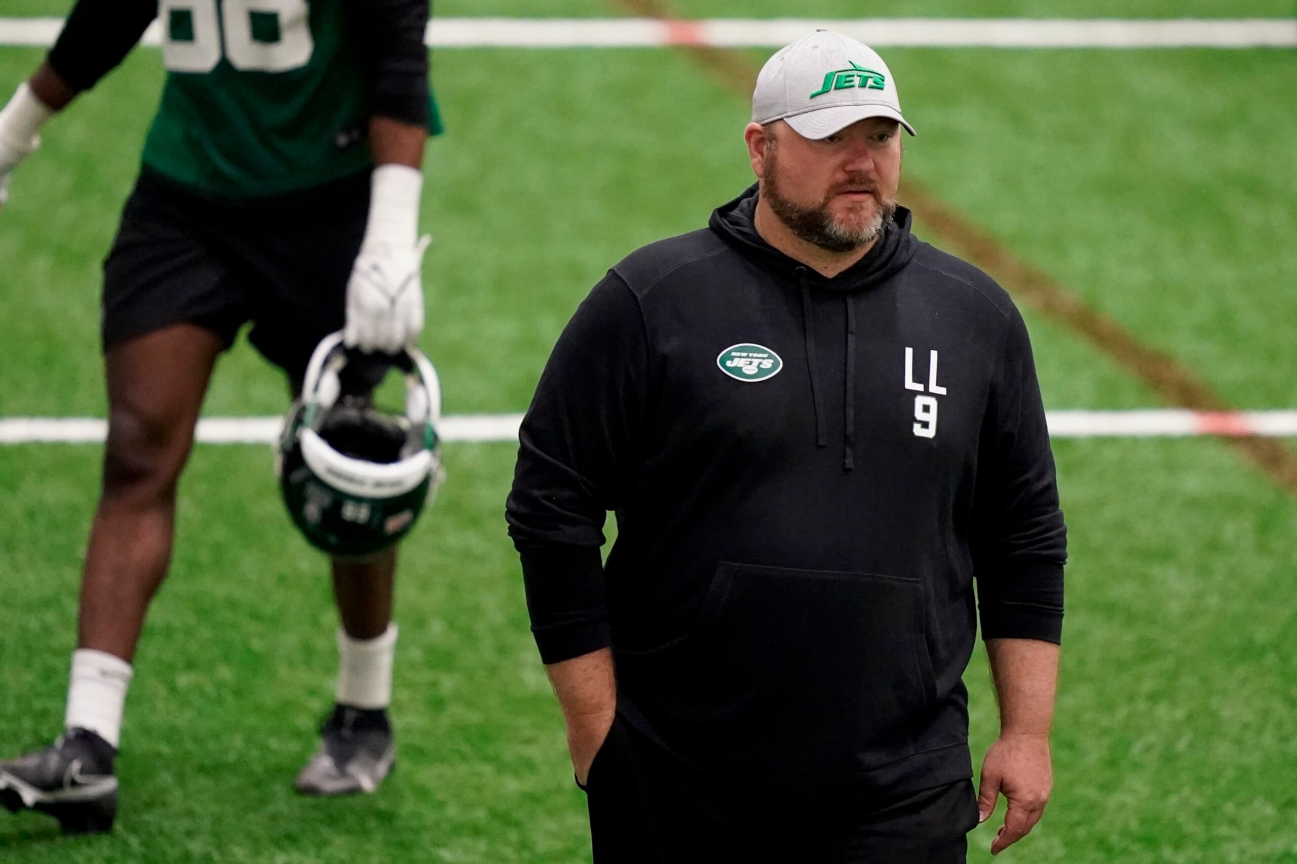 New York Jets' general manager Joe Douglas walks the field has his players practice during the NFL football team's training camp, Friday, May 6, 2022, in Florham Park, N.J. (AP Photo/John Minchillo) New York Jets' general manager Joe Douglas walks the field has his players practice during the NFL football team's training camp, Friday, May 6, 2022, in Florham Park, N.J. (AP Photo/John Minchillo)