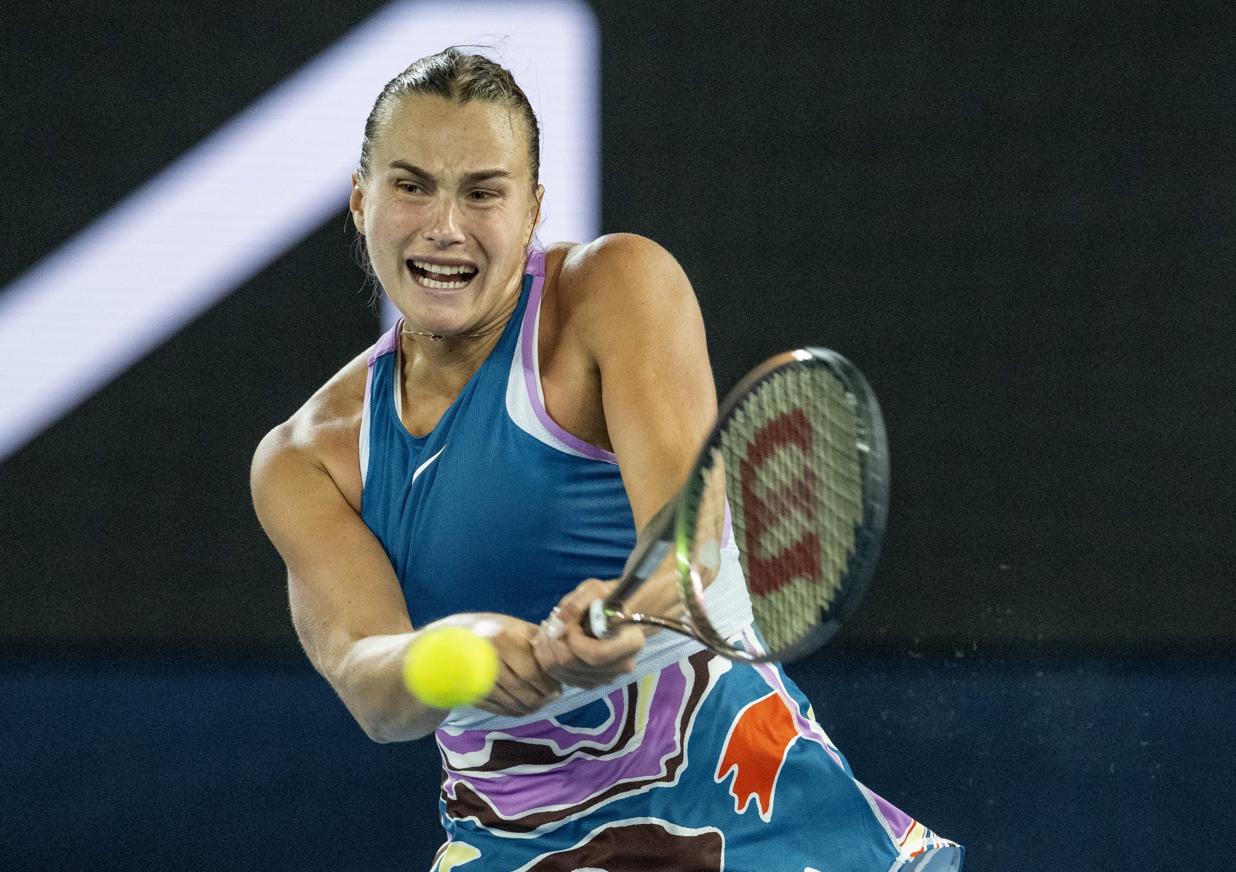 MELBOURNE, AUSTRALIA - JANUARY 26: Aryna Sabalenka plays a backhand in the Semifinal singles match against Magda Linette of Poland during day eleven of the 2023 Australian Open at Melbourne Park on January 26, 2023 in Melbourne, Australia. (Photo by Will Murray/Getty Images)