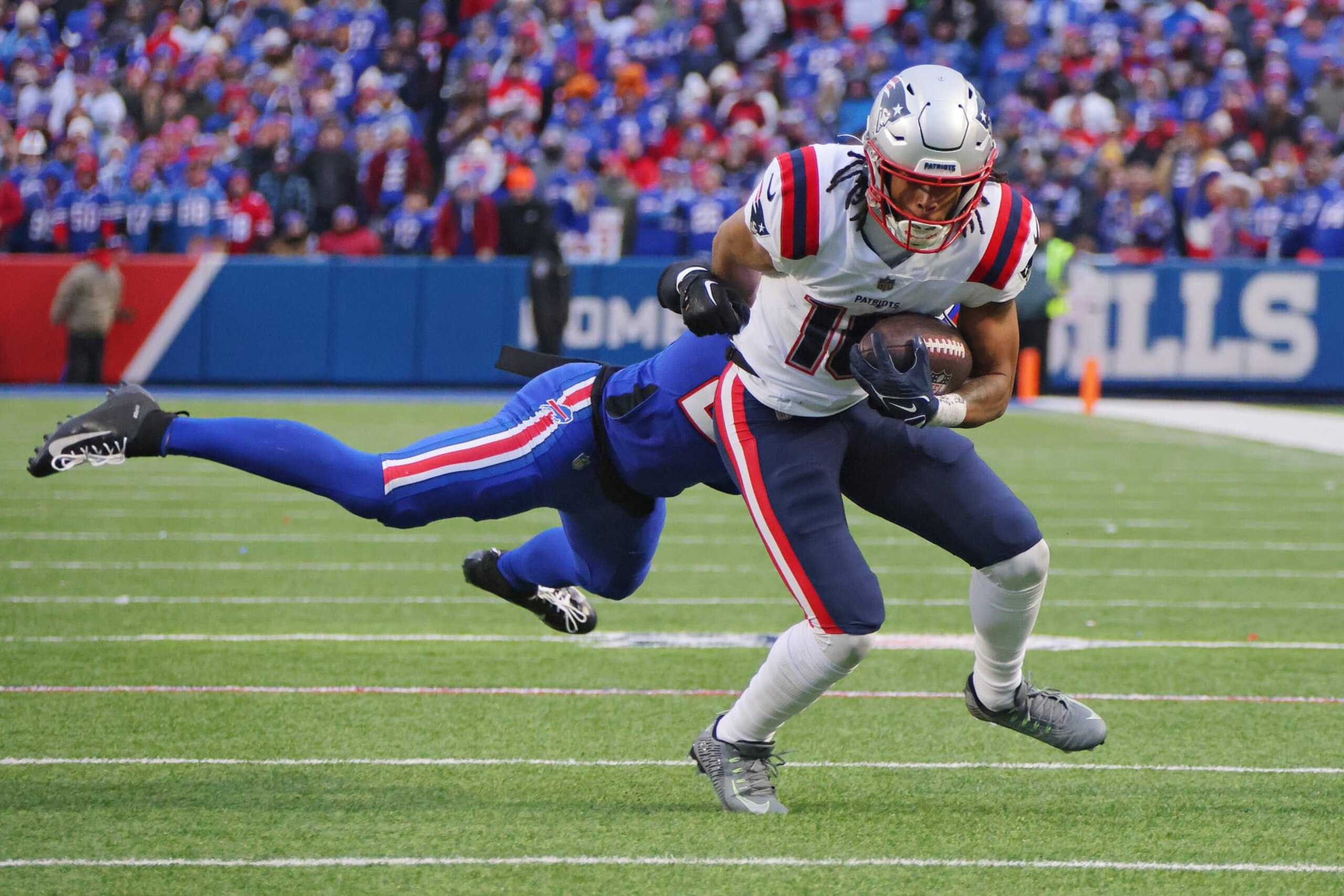 ORCHARD PARK, NEW YORK - JANUARY 08: Jordan Poyer #21 of the Buffalo Bills attempts to tackle Jakobi Meyers #16 of the New England Patriots during the fourth quarter at Highmark Stadium on January 08, 2023 in Orchard Park, New York. (Photo by Timothy T Ludwig/Getty Images)