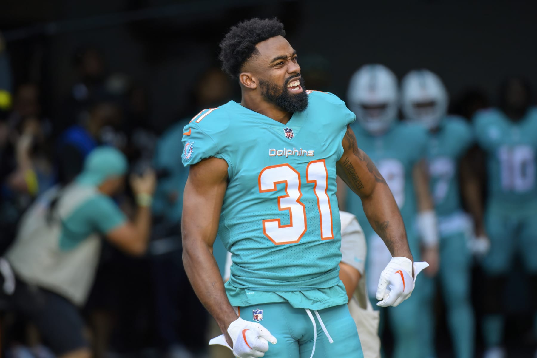 Miami Dolphins running back Raheem Mostert (31) yells as he is introduced to the fans before an NFL football game against the New York Jets, Sunday, Jan. 8, 2023, in Miami Gardens, Fla. (AP Photo/Doug Murray)