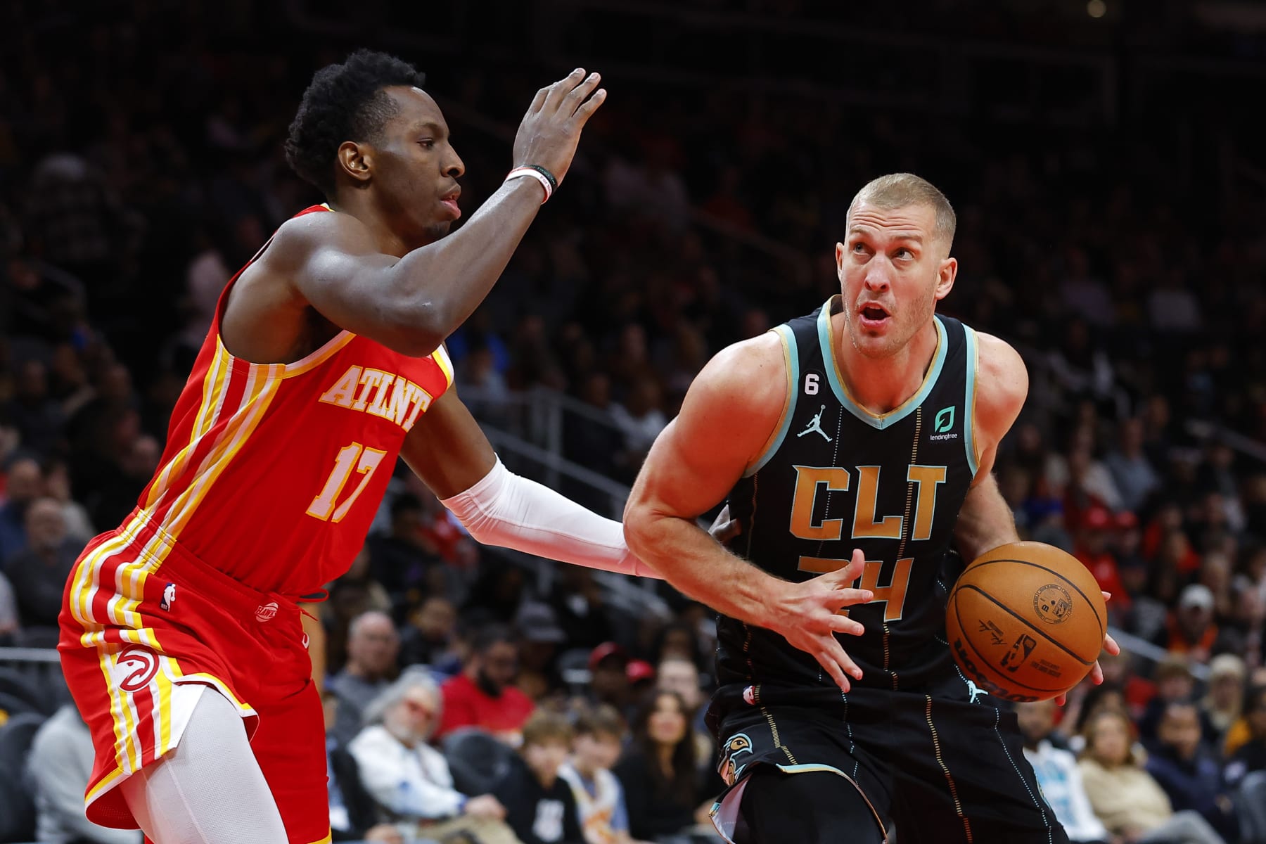 ATLANTA, GA - JANUARY 21: Mason Plumlee #24 of the Charlotte Hornets makes a move against Onyeka Okongwu #17 of the Atlanta Hawks during the first half at State Farm Arena on January 21, 2023 in Atlanta, Georgia. NOTE TO USER: User expressly acknowledges and agrees that, by downloading and or using this photograph, User is consenting to the terms and conditions of the Getty Images License Agreement. (Photo by Todd Kirkland/Getty Images)