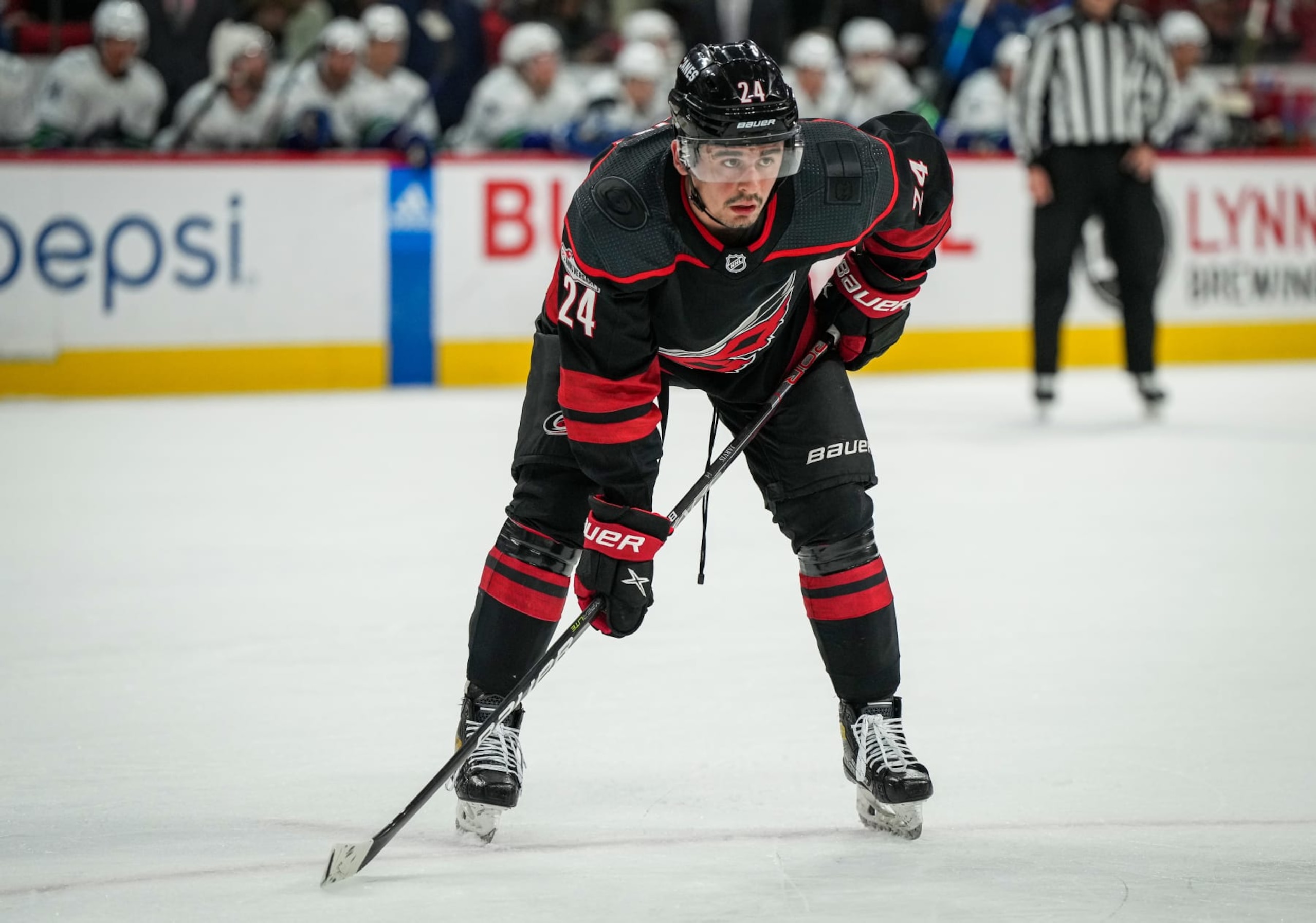 RALEIGH, NORTH CAROLINA - JANUARY 15: Seth Jarvis #24 of the Carolina Hurricanes lines up during the first period against the Vancouver Canucks at PNC Arena on January 15, 2023 in Raleigh, North Carolina. (Photo by Josh Lavallee/NHLI via Getty Images)