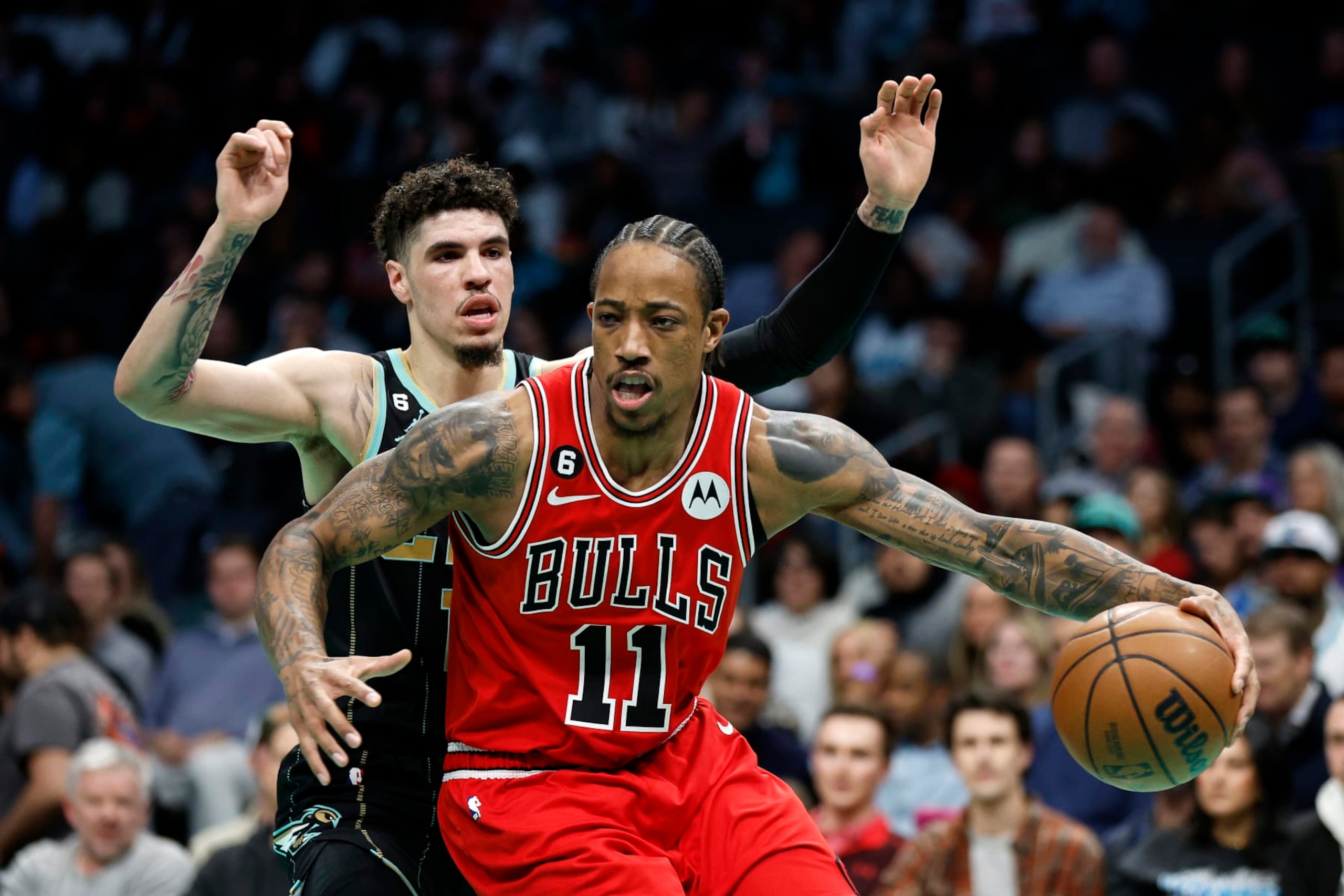 CHARLOTTE, NORTH CAROLINA - JANUARY 26: DeMar DeRozan #11 of the Chicago Bulls drives to the basket against LaMelo Ball #1 of the Charlotte Hornets during the second quarter of the game at Spectrum Center on January 26, 2023 in Charlotte, North Carolina. NOTE TO USER: User expressly acknowledges and agrees that, by downloading and or using this photograph, User is consenting to the terms and conditions of the Getty Images License Agreement.  (Photo by Jared C. Tilton/Getty Images)