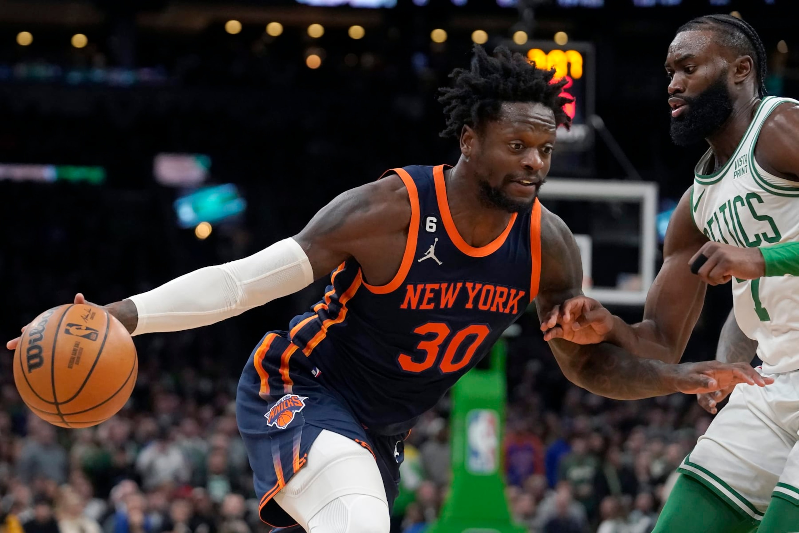 New York Knicks forward Julius Randle (30) drives toward the basket past Boston Celtics guard Jaylen Brown (7) in the second half of an NBA basketball game, Thursday, Jan. 26, 2023, in Boston. (AP Photo/Steven Senne)